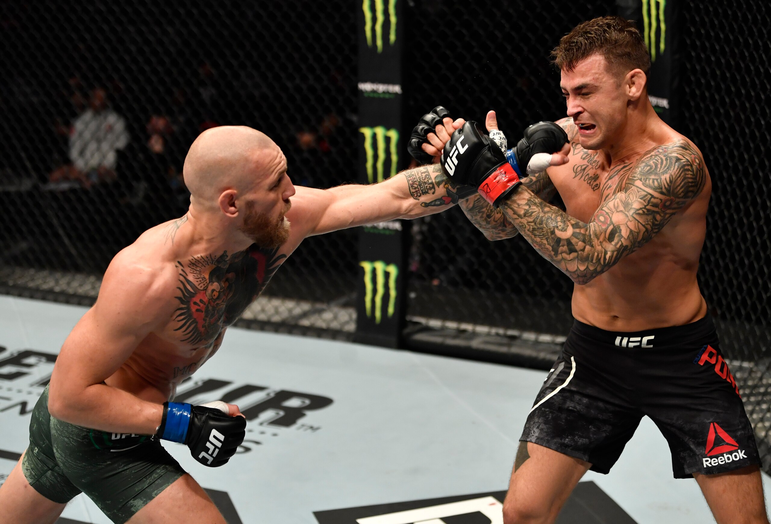 ABU DHABI, UNITED ARAB EMIRATES - JANUARY 23: (L-R) Conor McGregor of Ireland punches Dustin Poirier in a lightweight fight during the UFC 257 event inside Etihad Arena on UFC Fight Island on January 23, 2021 in Abu Dhabi, United Arab Emirates. (Photo by Jeff Bottari/Zuffa LLC)