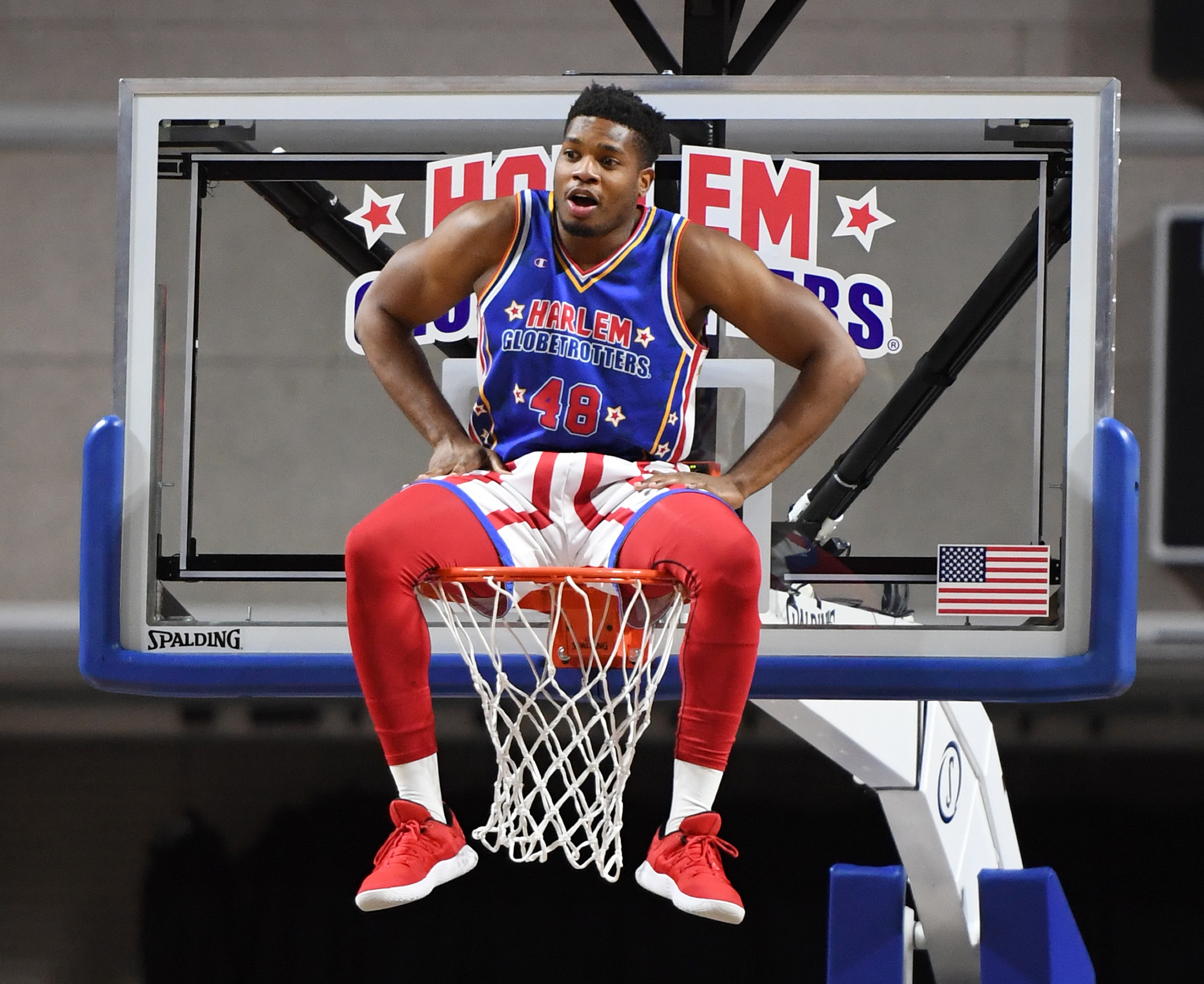 LAS VEGAS, NEVADA - AUGUST 25:  Antjuan "Clutch" Ball #48 of the Harlem Globetrotters sits on the rim during the team's exhibition game against the Washington Generals at the Orleans Arena on August 25, 2019 in Las Vegas, Nevada.  (Photo by Ethan Miller/Getty Images)