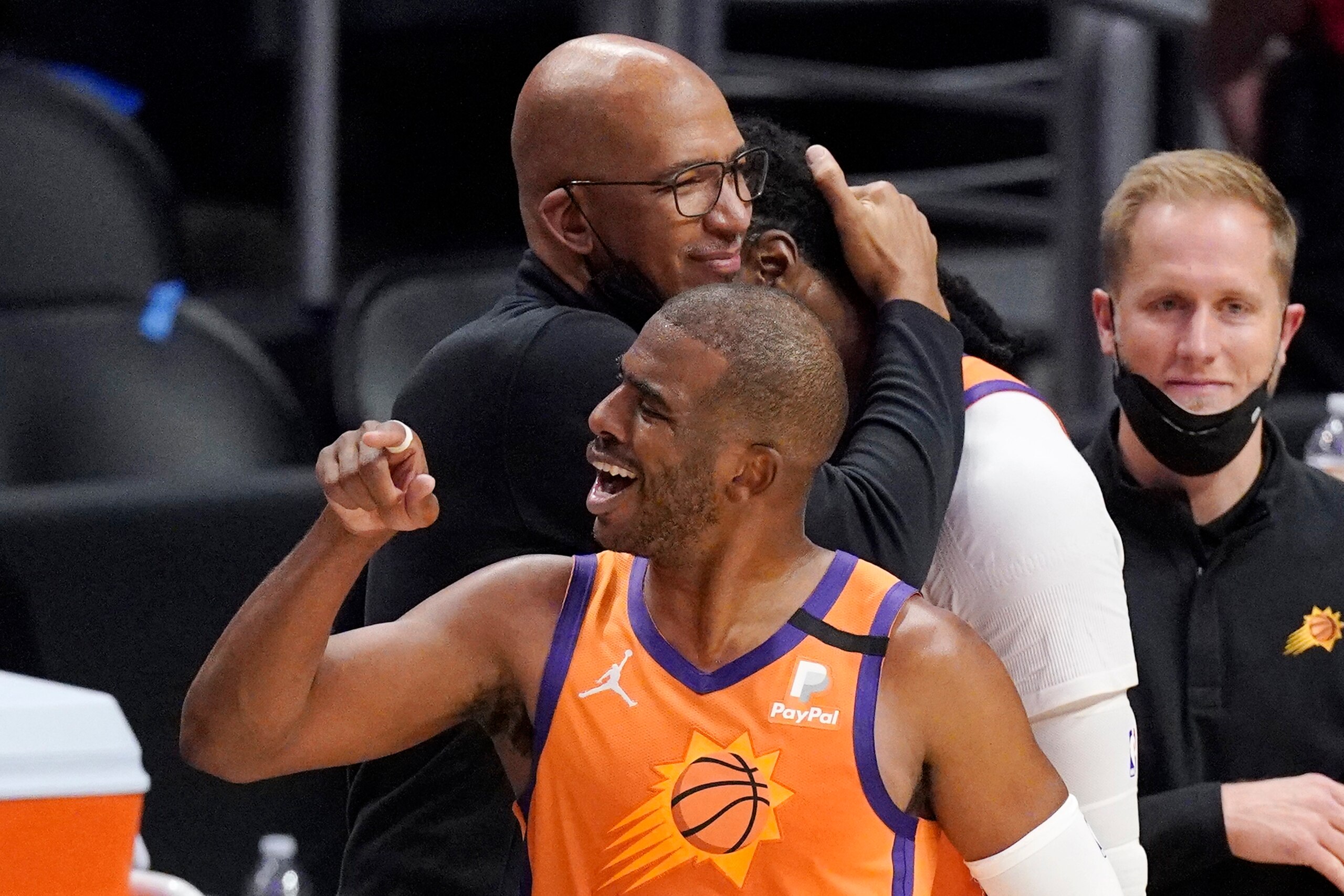 Phoenix Suns head coach Monty Williams, left, hugs Jae Crowder, second from right, while guard Chris Paul celebrates as time runs out in Game 6 of the NBA basketball Western Conference Finals against the Los Angeles Clippers Wednesday, June 30, 2021, in Los Angeles. The Suns won the game 130-103 to take the series 4-2. (AP Photo/Mark J. Terrill) Phoenix Suns head coach Monty Williams, left, hugs Jae Crowder, second from right, while guard Chris Paul celebrates as time runs out in Game 6 of the NBA basketball Western Conference Finals against the Los Angeles Clippers Wednesday, June 30, 2021, in Los Angeles. The Suns won the game 130-103 to take the series 4-2. (AP Photo/Mark J. Terrill)