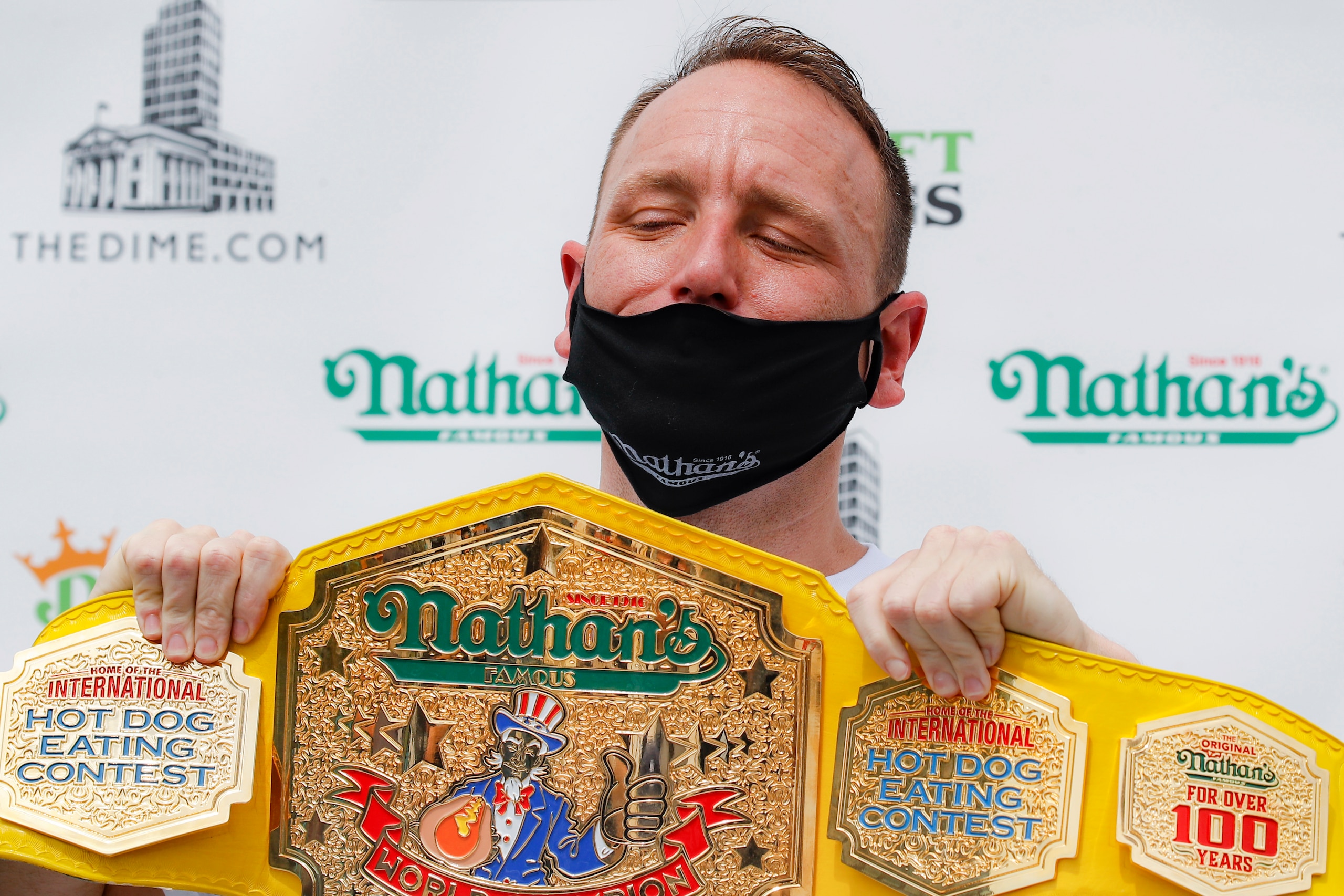 Competitive eater Joey Chestnut holds his championship belt during a weigh-in before the Nathan's Famous July Fourth hot dog eating contest, Friday, July 3, 2020, in the Brooklyn borough of New York. The weigh-in was held in a private, socially-distanced ceremony in the Williamsburg neighborhood due to COVID-19 concerns. (AP Photo/John Minchillo)