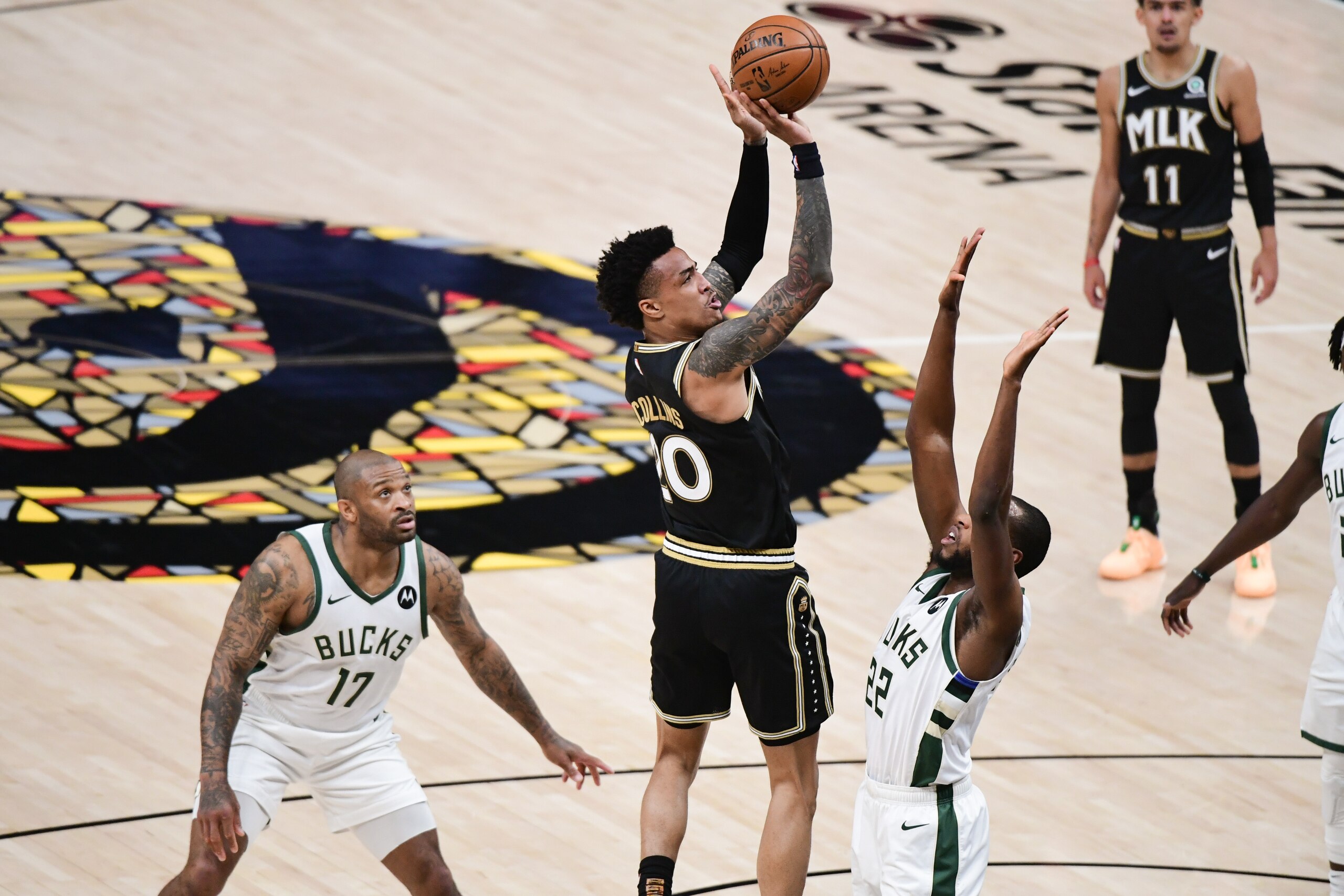ATLANTA, GA - JULY 3: John Collins #20 of the Atlanta Hawks shoots the ball during the game against the Milwaukee Bucks during Game 6 of the Eastern Conference Finals of the 2021 NBA Playoffs on July 3, 2021 at State Farm Arena in Atlanta, Georgia.  NOTE TO USER: User expressly acknowledges and agrees that, by downloading and/or using this Photograph, user is consenting to the terms and conditions of the Getty Images License Agreement. Mandatory Copyright Notice: Copyright 2021 NBAE (Photo by Adam Hagy/NBAE via Getty Images)