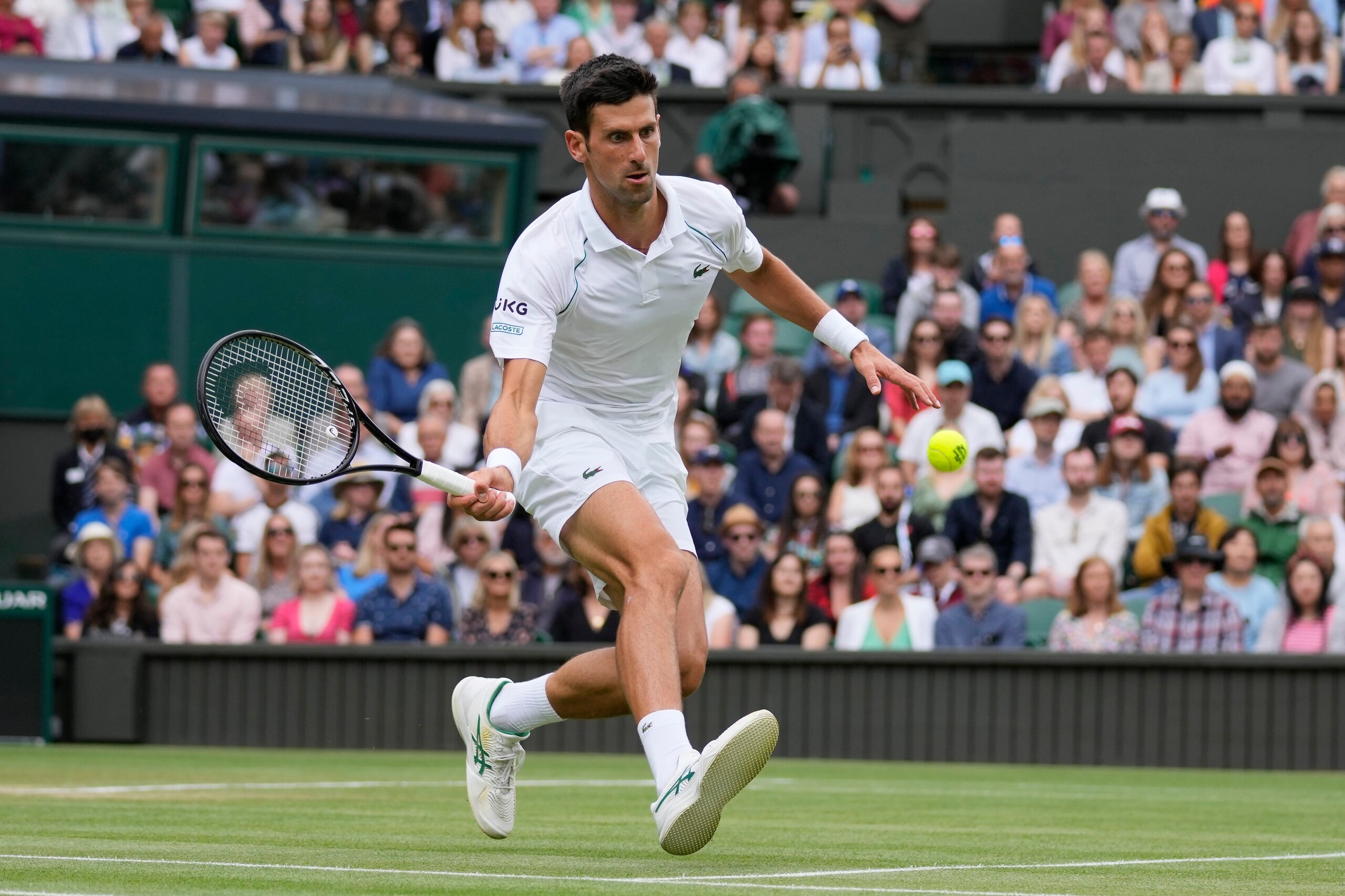 Serbia's Novak Djokovic plays a return to Chile's Cristian Garin during the men's singles fourth round match on day seven of the Wimbledon Tennis Championships in London, Monday, July 5, 2021. (AP Photo/Kirsty Wigglesworth)