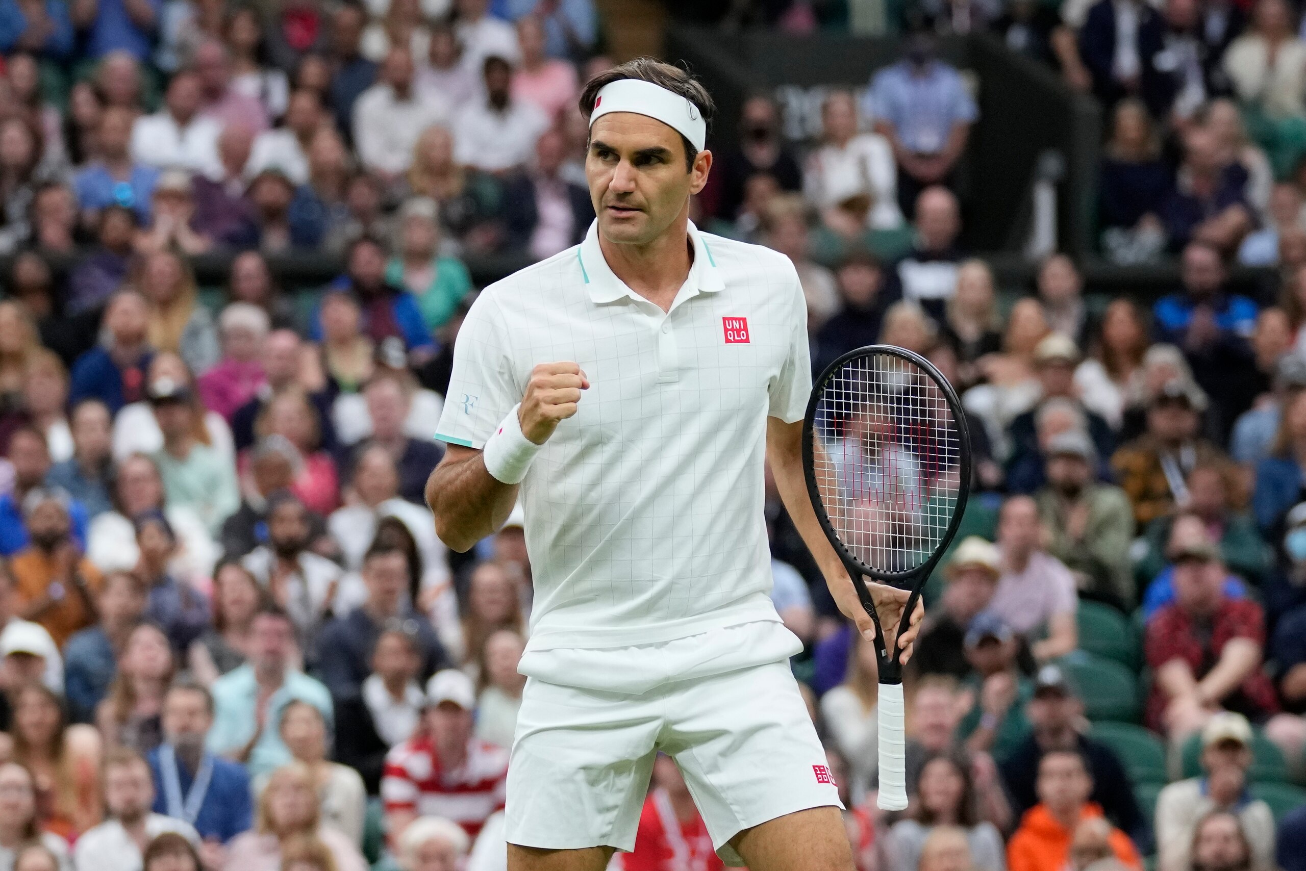 Switzerland's Roger Federer celebrates winning a point against Italy's Lorenzo Sonego during the men's singles fourth round match on day seven of the Wimbledon Tennis Championships in London, Monday, July 5, 2021. (AP Photo/Kirsty Wigglesworth)