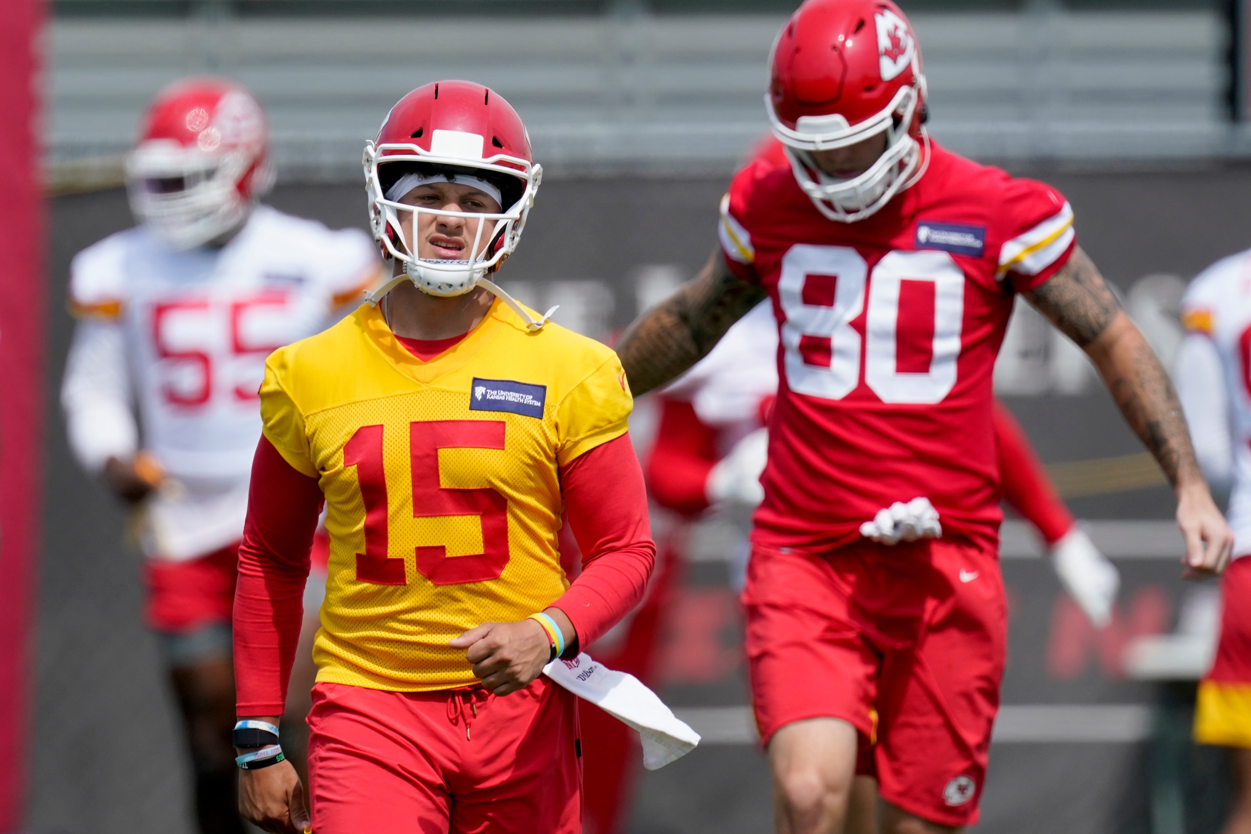 Kansas City Chiefs quarterback Patrick Mahomes (15) warms up with teammates during the NFL football team's minicamp Wednesday, June 16, 2021, in Kansas City, Mo. (AP Photo/Charlie Riedel)