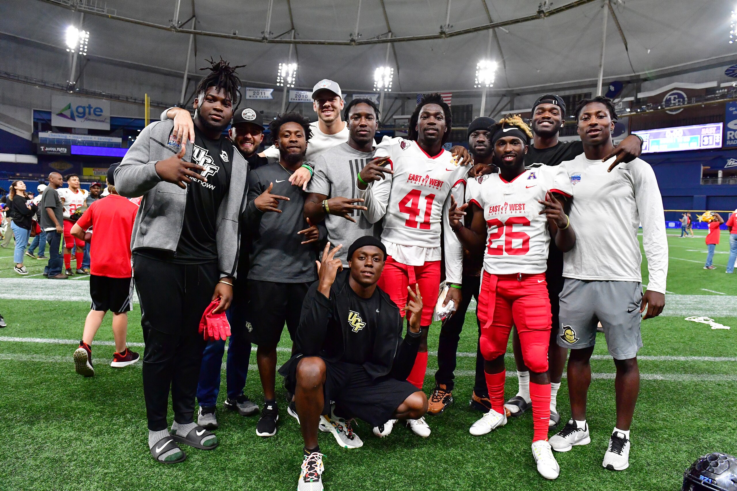 ST PETERSBURG, FLORIDA - JANUARY 18: Nevelle Clarke #41 and Adrian Killins Jr. #26 both of Central Florida pose with UCF teammates following the 2020 East West Shrine Bowl at Tropicana Field on January 18, 2020 in St Petersburg, Florida. (Photo by Julio Aguilar/Getty Images) ST PETERSBURG, FLORIDA - JANUARY 18: Nevelle Clarke #41 and Adrian Killins Jr. #26 both of Central Florida pose with UCF teammates following the 2020 East West Shrine Bowl at Tropicana Field on January 18, 2020 in St Petersburg, Florida. (Photo by Julio Aguilar/Getty Images)