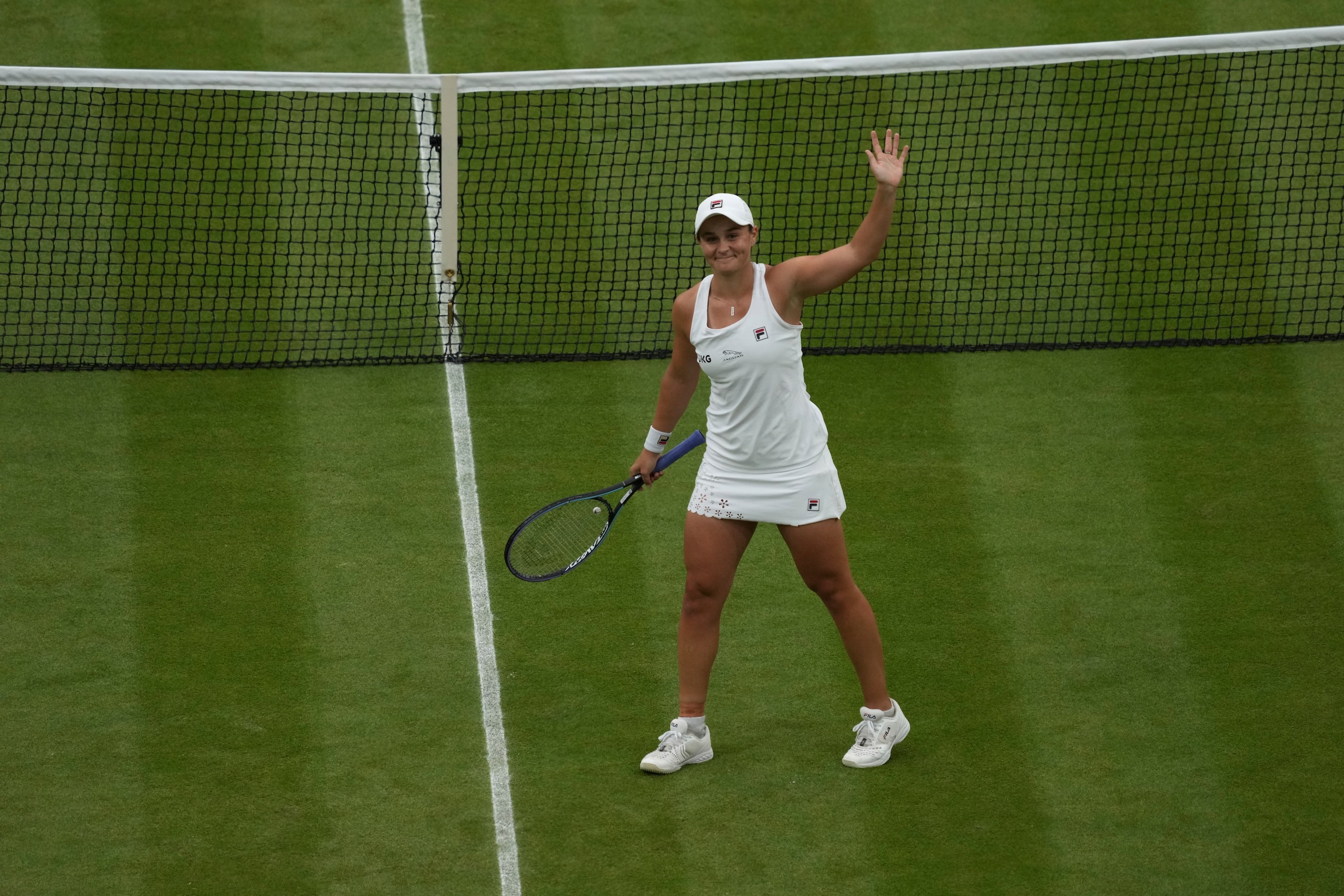 Australia's Ashleigh Barty celebrates after defeating compatriot Ajla Tomljanovic during the women's singles quarterfinals match on day eight of the Wimbledon Tennis Championships in London, Tuesday, July 6, 2021. (AP Photo/Alberto Pezzali)