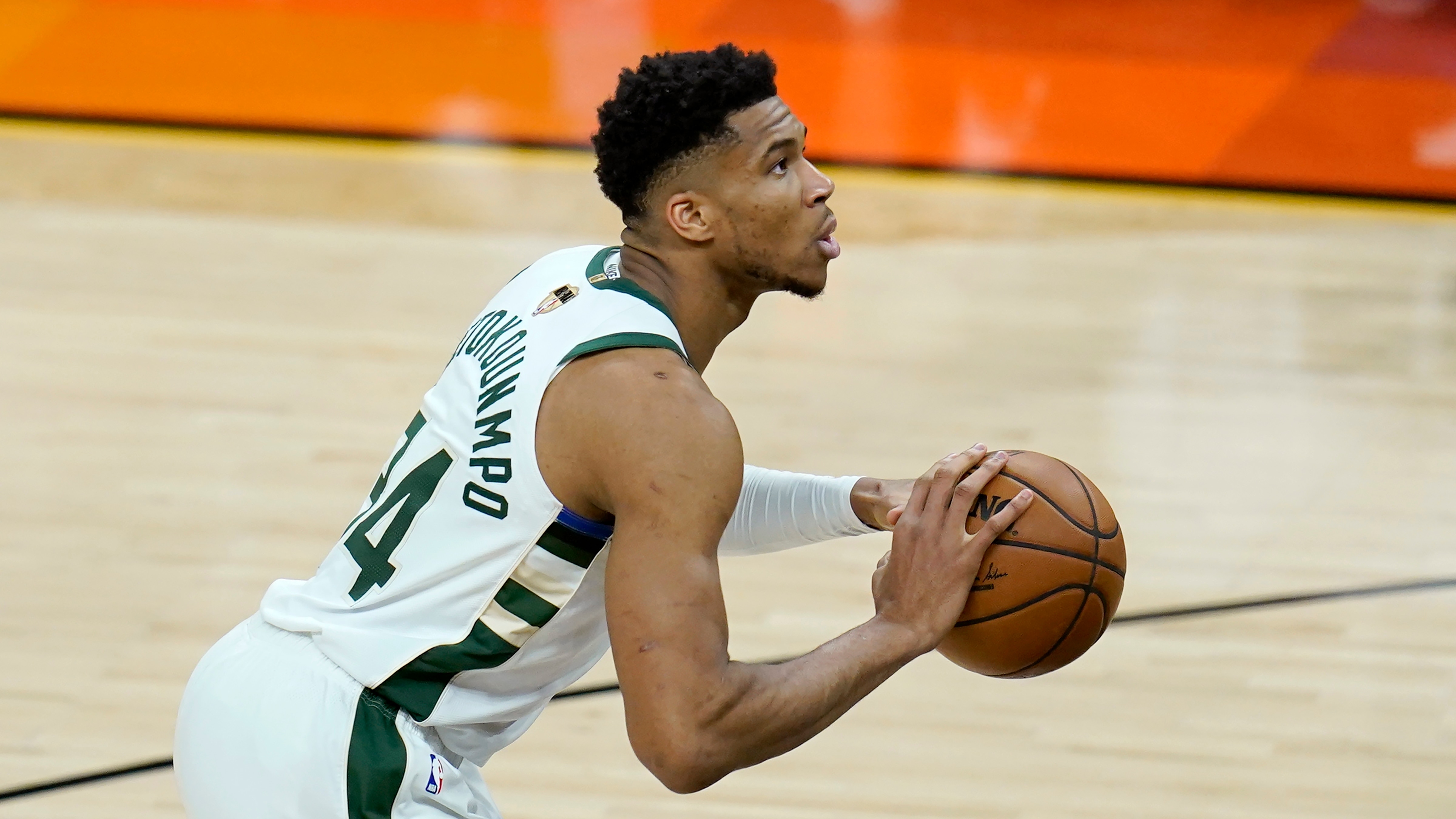 Milwaukee Bucks forward Giannis Antetokounmpo shoots a foul shot during the first half of Game 1 of basketball's NBA Finals against the Phoenix Suns, Tuesday, July 6, 2021, in Phoenix. (AP Photo/Ross D. Franklin)