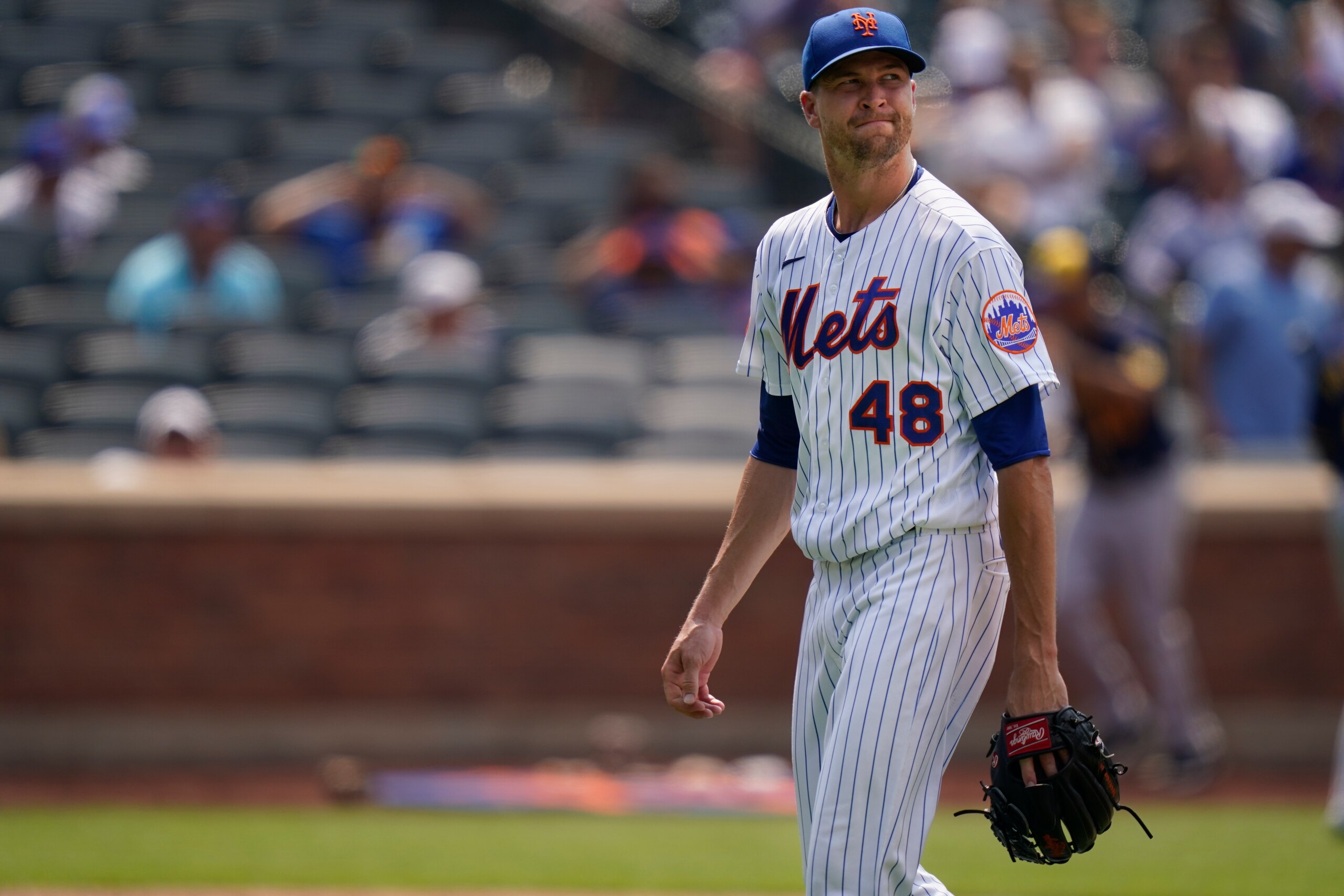 New York Mets starting pitcher Jacob deGrom (48) reacts as he leaves the field after the fifth inning of the first baseball game of a doubleheader against the Milwaukee Brewers, Wednesday, July 7, 2021, in New York. (AP Photo/Frank Franklin II)
