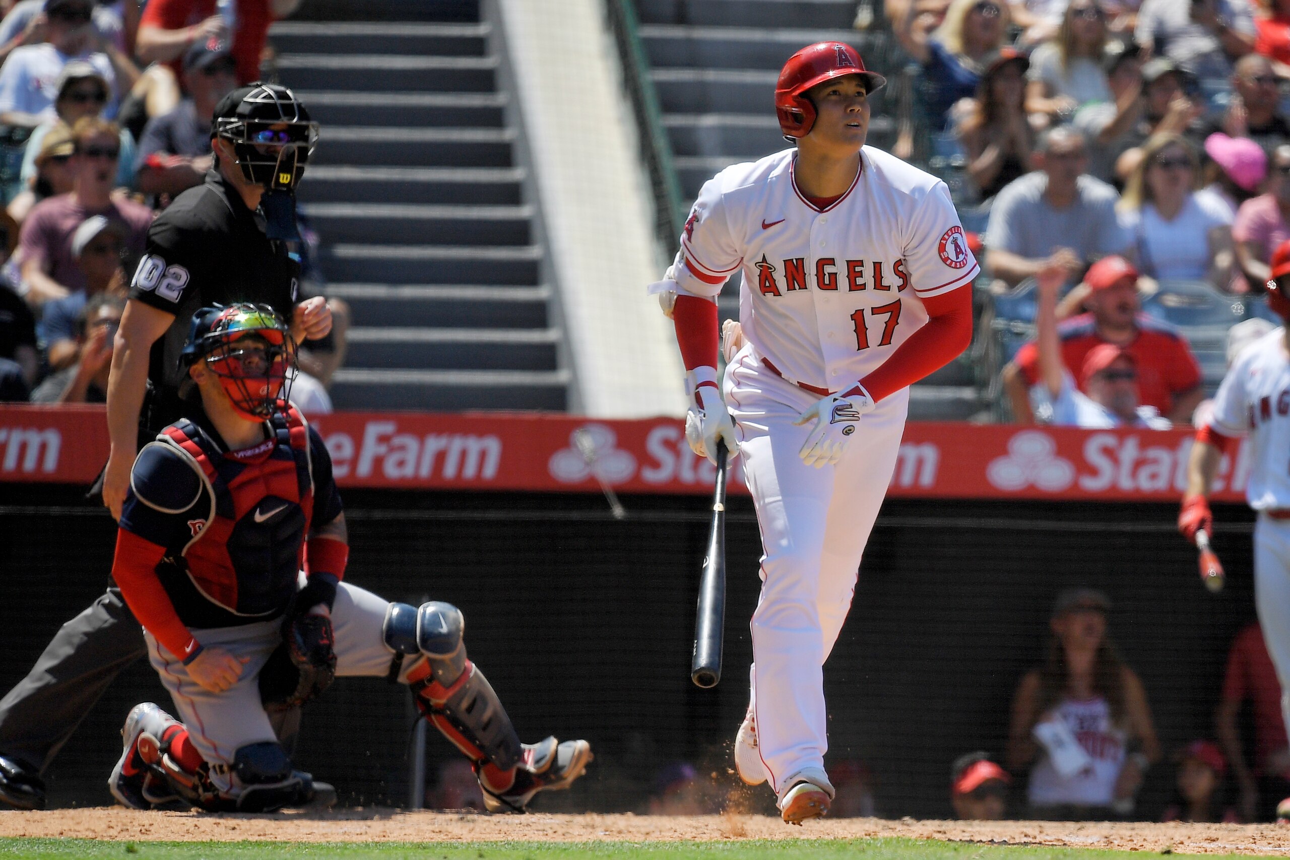 Los Angeles Angels' Shohei Ohtani, right, heads to first after hitting a solo home run as Boston Red Sox catcher Christian Vazquez, center, and home plate umpire Adam Beck watch during the fifth inning of a baseball game Wednesday, July 7, 2021, in Anaheim, Calif. (AP Photo/Mark J. Terrill) Los Angeles Angels' Shohei Ohtani, right, heads to first after hitting a solo home run as Boston Red Sox catcher Christian Vazquez, center, and home plate umpire Adam Beck watch during the fifth inning of a baseball game Wednesday, July 7, 2021, in Anaheim, Calif. (AP Photo/Mark J. Terrill)