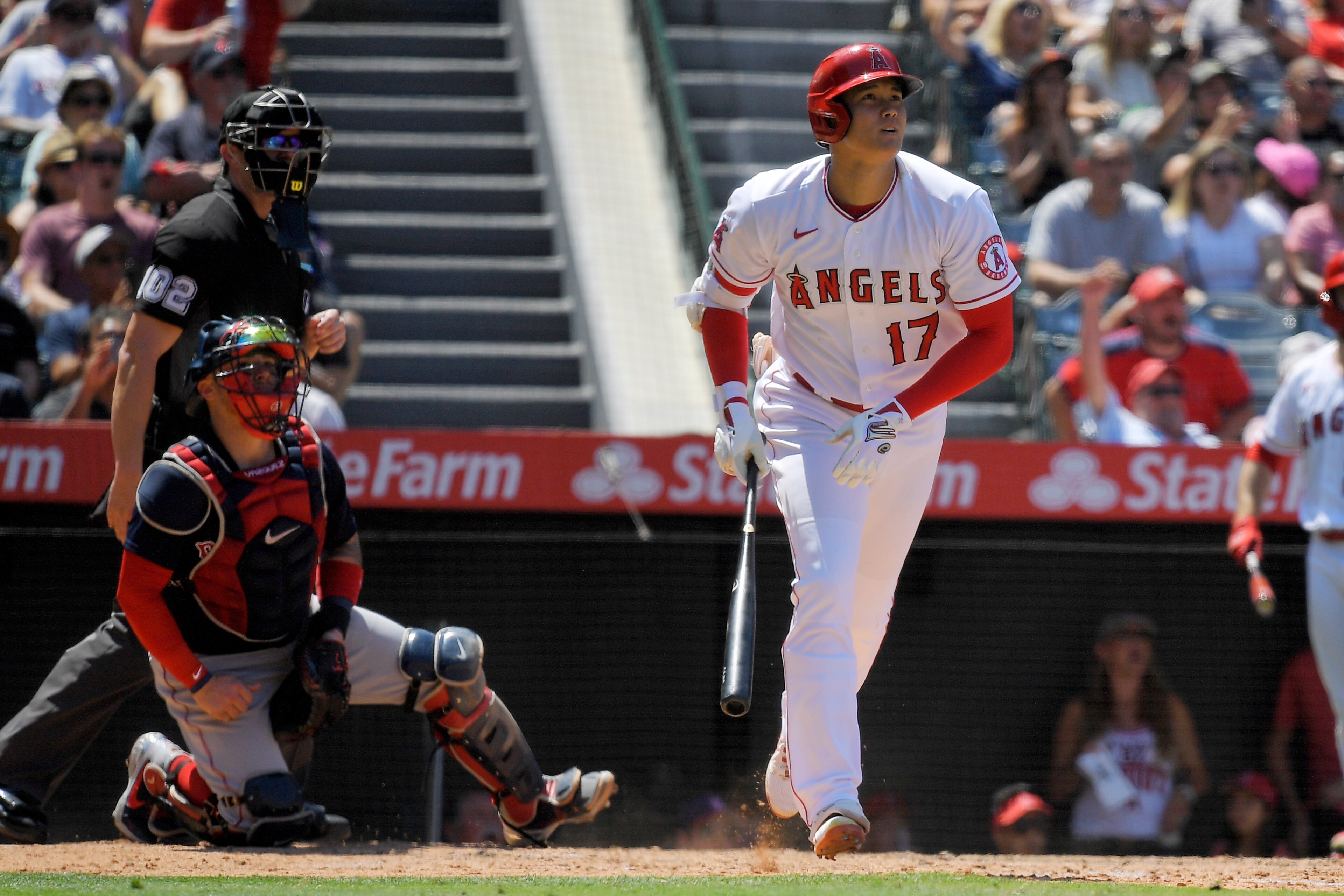 Los Angeles Angels' Shohei Ohtani, right, heads to first after hitting a solo home run as Boston Red Sox catcher Christian Vazquez, center, and home plate umpire Adam Beck watch during the fifth inning of a baseball game Wednesday, July 7, 2021, in Anaheim, Calif. (AP Photo/Mark J. Terrill) Los Angeles Angels' Shohei Ohtani, right, heads to first after hitting a solo home run as Boston Red Sox catcher Christian Vazquez, center, and home plate umpire Adam Beck watch during the fifth inning of a baseball game Wednesday, July 7, 2021, in Anaheim, Calif. (AP Photo/Mark J. Terrill)