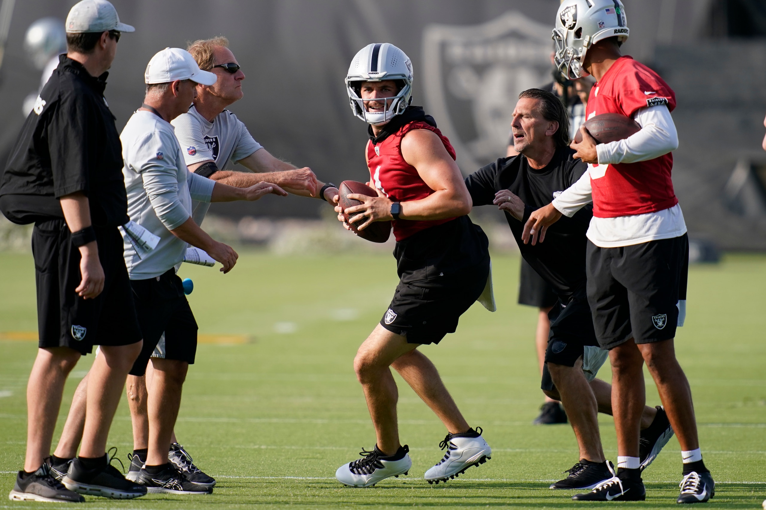 Las Vegas Raiders quarterback Derek Carr, center, takes part in a drill during an NFL football practice Tuesday, June 15, 2021, in Henderson, Nev. (AP Photo/John Locher) Las Vegas Raiders quarterback Derek Carr, center, takes part in a drill during an NFL football practice Tuesday, June 15, 2021, in Henderson, Nev. (AP Photo/John Locher)