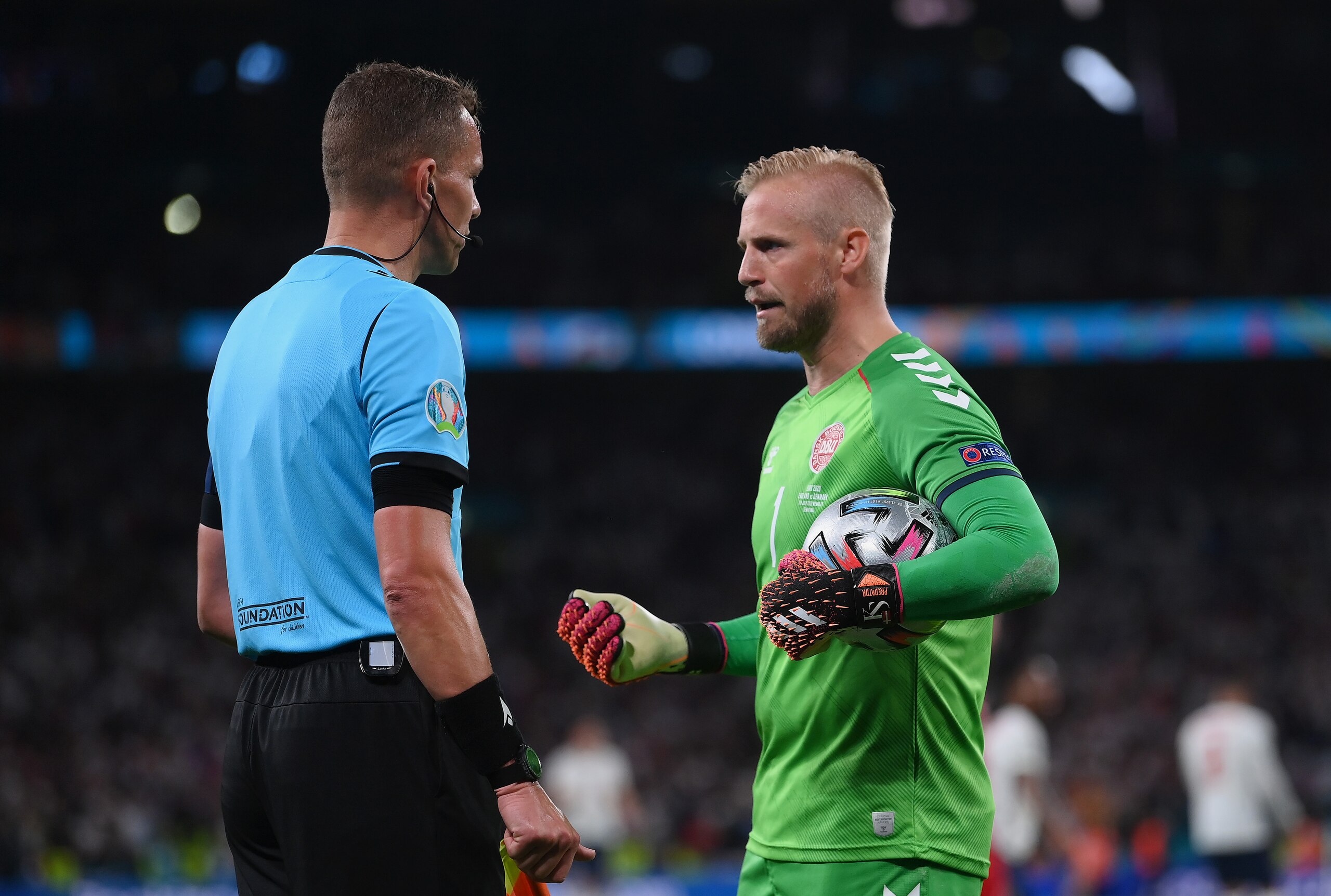 LONDON, ENGLAND - JULY 07: Kasper Schmeichel of Denmark confronts Assistant Referee, Hessel Steegstra as Match Referee, Danny Makkelie (not pictured) awards England a penalty during the UEFA Euro 2020 Championship Semi-final match between England and Denmark at Wembley Stadium on July 07, 2021 in London, England. (Photo by Laurence Griffiths/Getty Images)