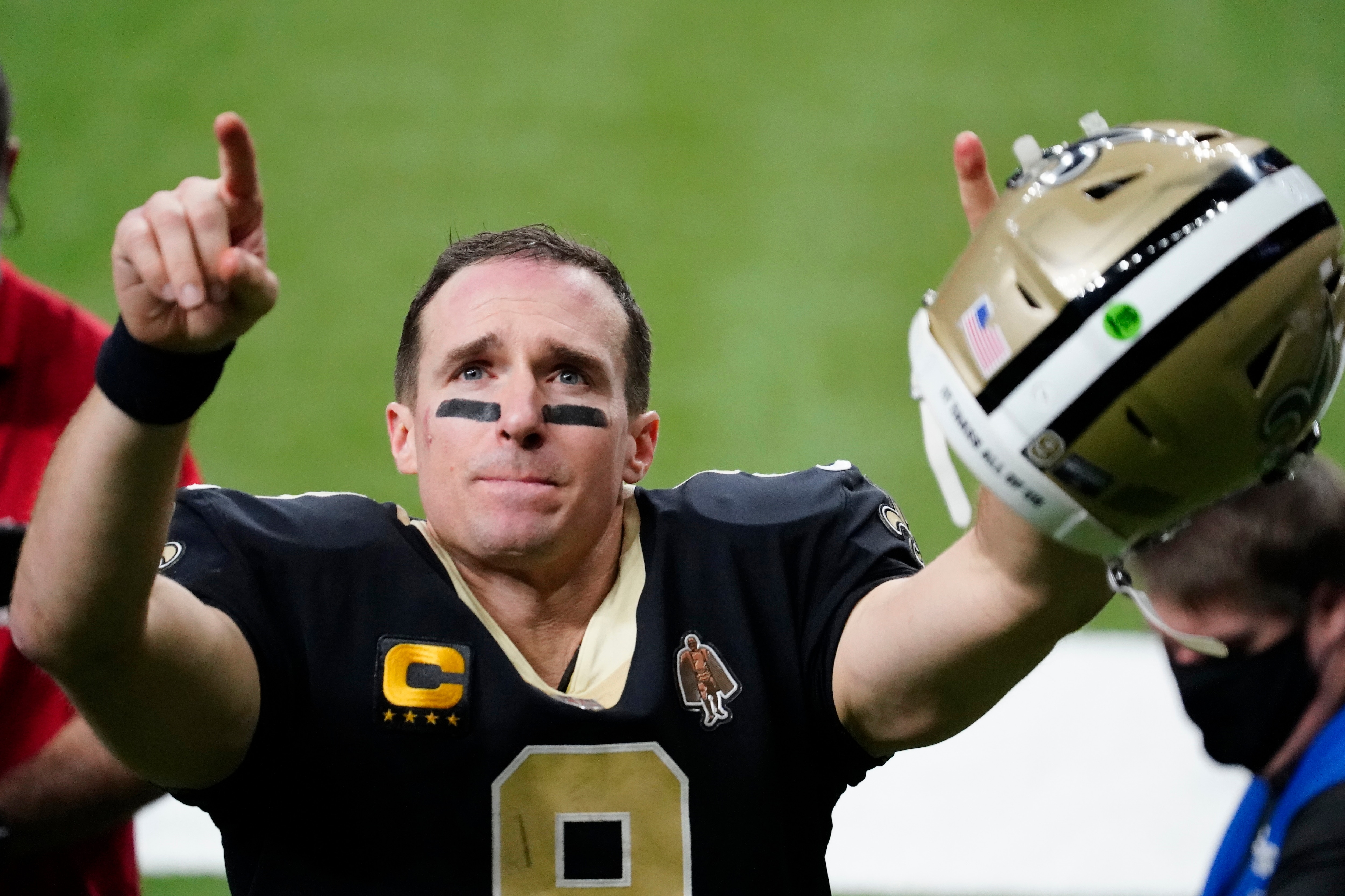 New Orleans Saints quarterback Drew Brees gestures to his family and fans after an NFL divisional round playoff football game against the Tampa Bay Buccaneers, Sunday, Jan. 17, 2021, in New Orleans. The Buccaneers won 30-20. (AP Photo/Brynn Anderson)