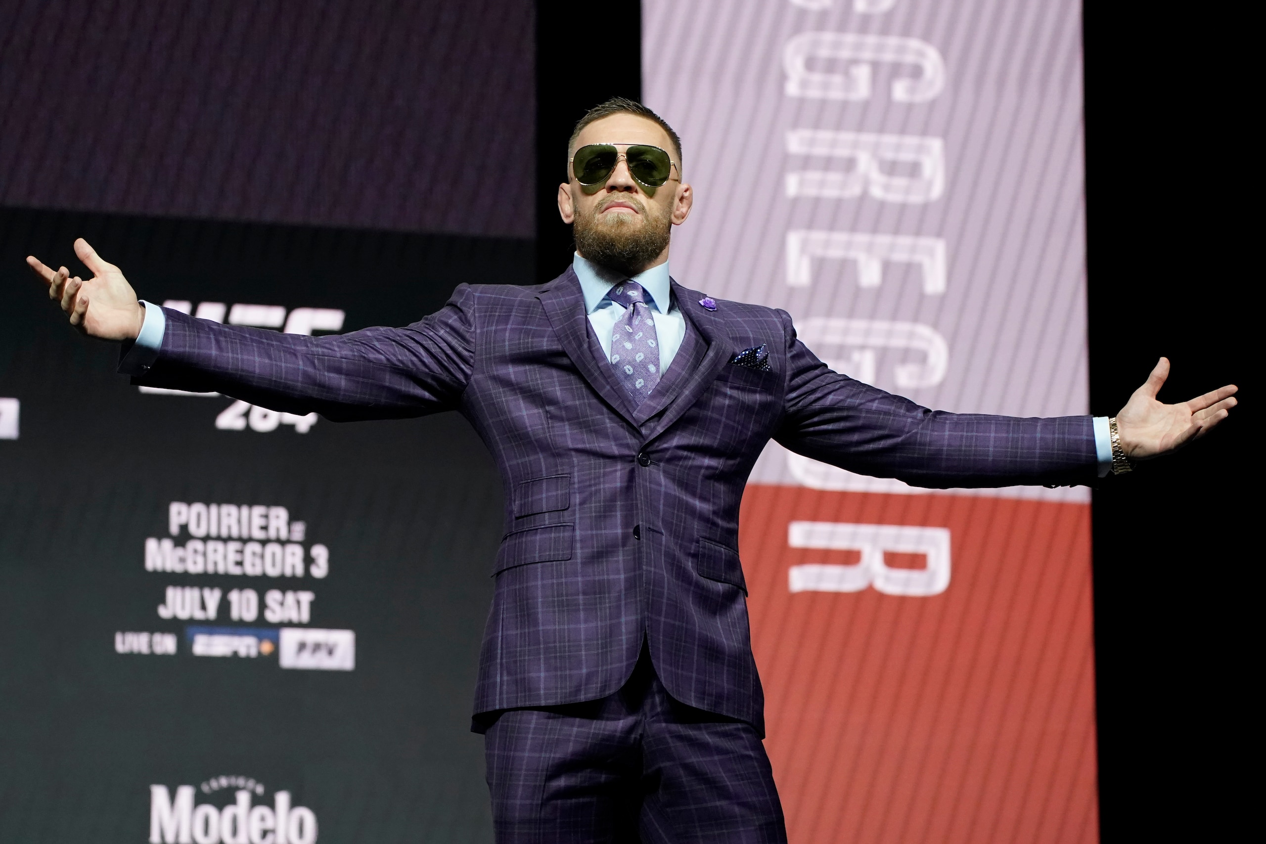 Conor McGregor motions to the crowd during a news conference for a UFC 264 mixed martial arts bout Thursday, July 8, 2021, in Las Vegas. McGregor is scheduled to fight Dustin Poirier in a lightweight bout Saturday in Las Vegas (AP Photo/John Locher)