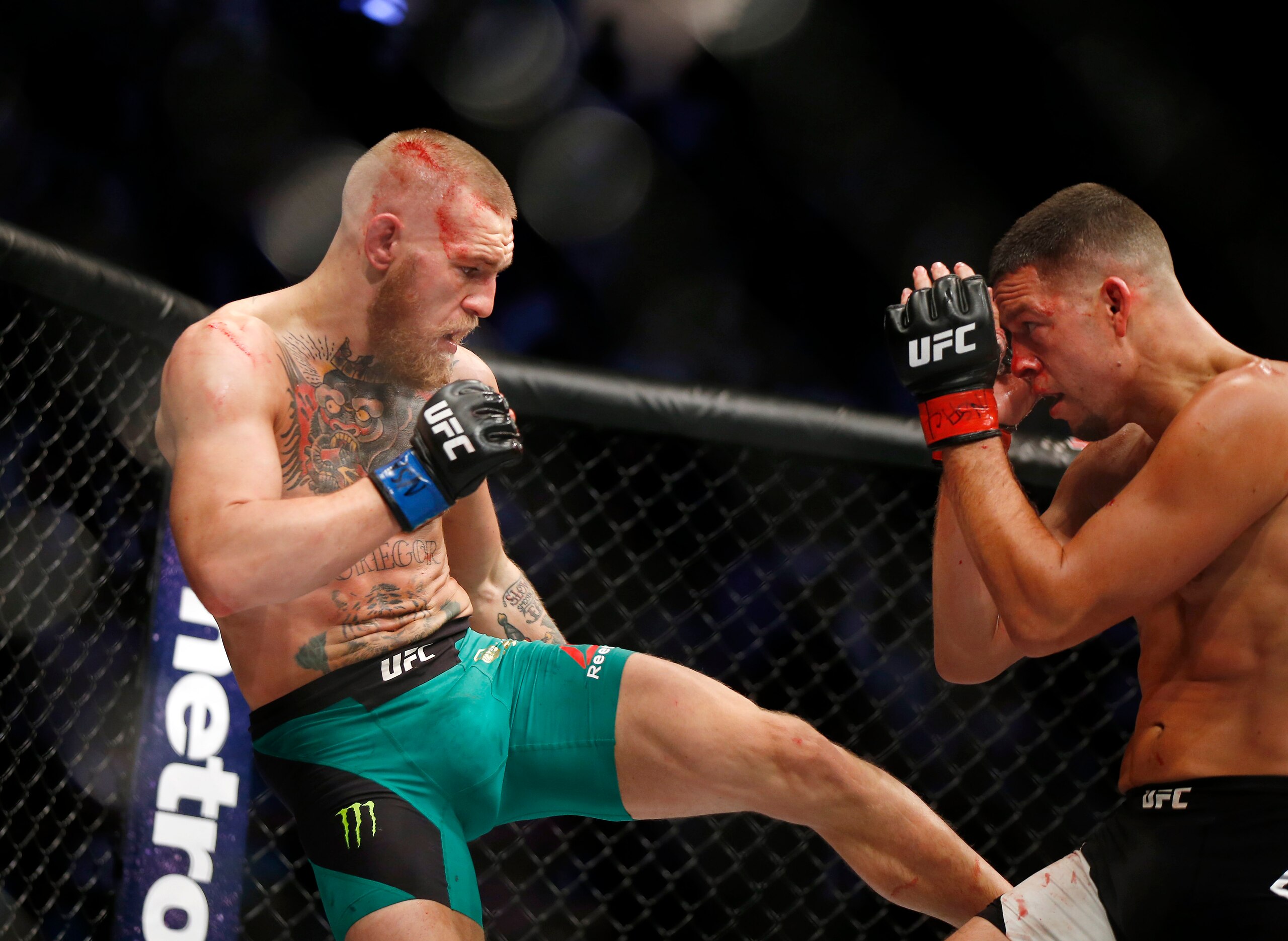 Conor McGregor fights Nate Diaz during their welterweight mixed martial arts bout at UFC 202 on Saturday, Aug. 20, 2016, in Las Vegas. McGregor won by split decision. (AP Photo/Isaac Brekken)