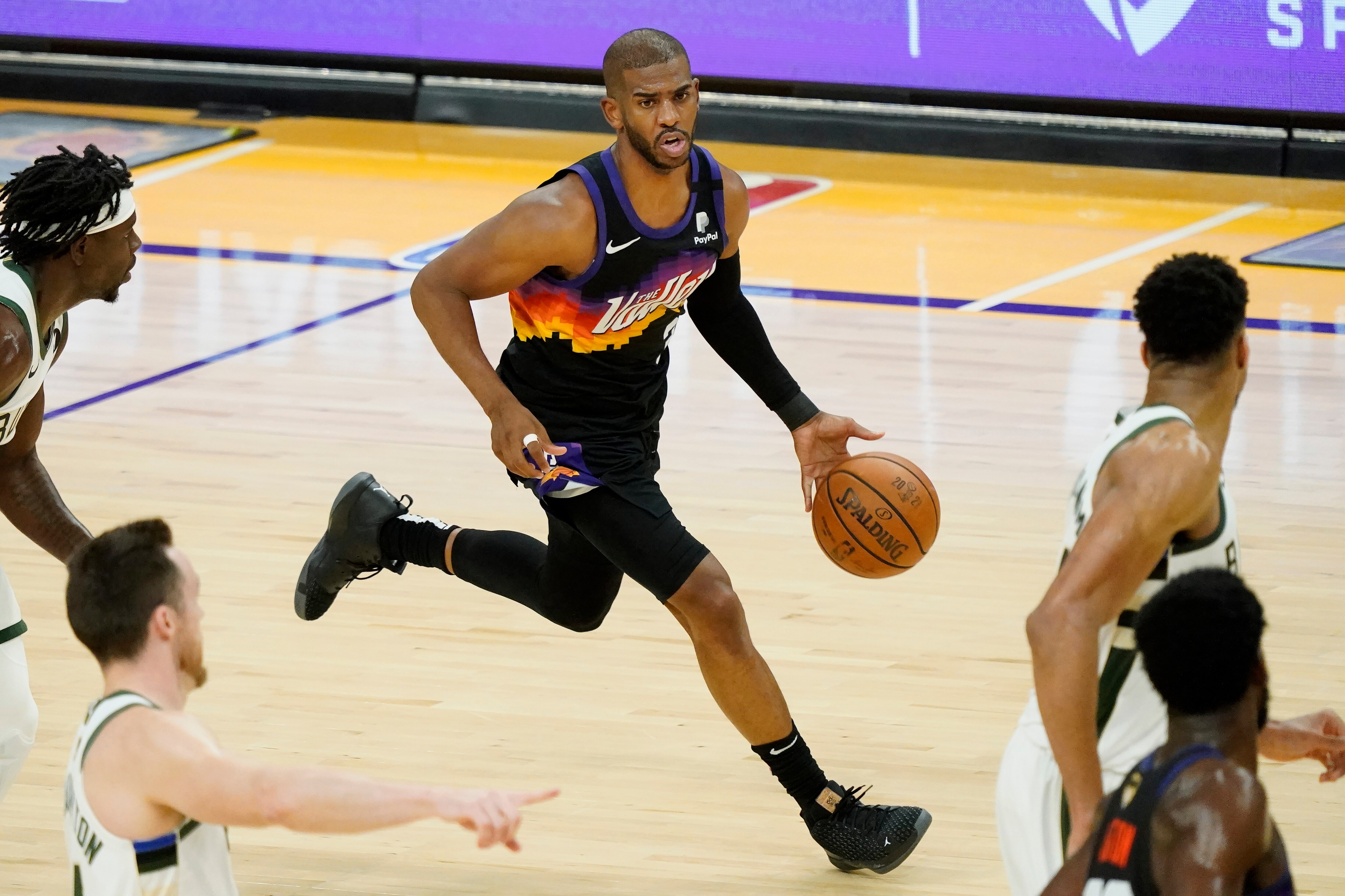 Phoenix Suns guard Chris Paul (3) dribbles against the Milwaukee Bucks during the first half of Game 2 of basketball's NBA Finals, Thursday, July 8, 2021, in Phoenix. (AP Photo/Matt York)