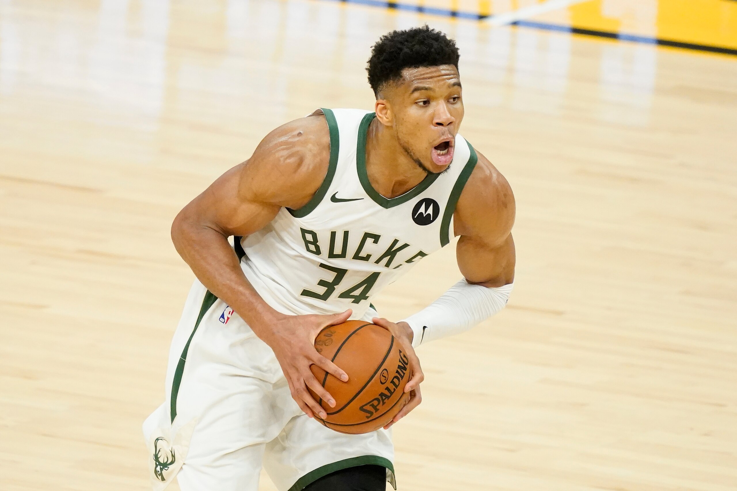 Milwaukee Bucks forward Giannis Antetokounmpo (34) handles the ball against the Phoenix Suns during the second half of Game 2 of basketball's NBA Finals, Thursday, July 8, 2021, in Phoenix. (AP Photo/Matt York)