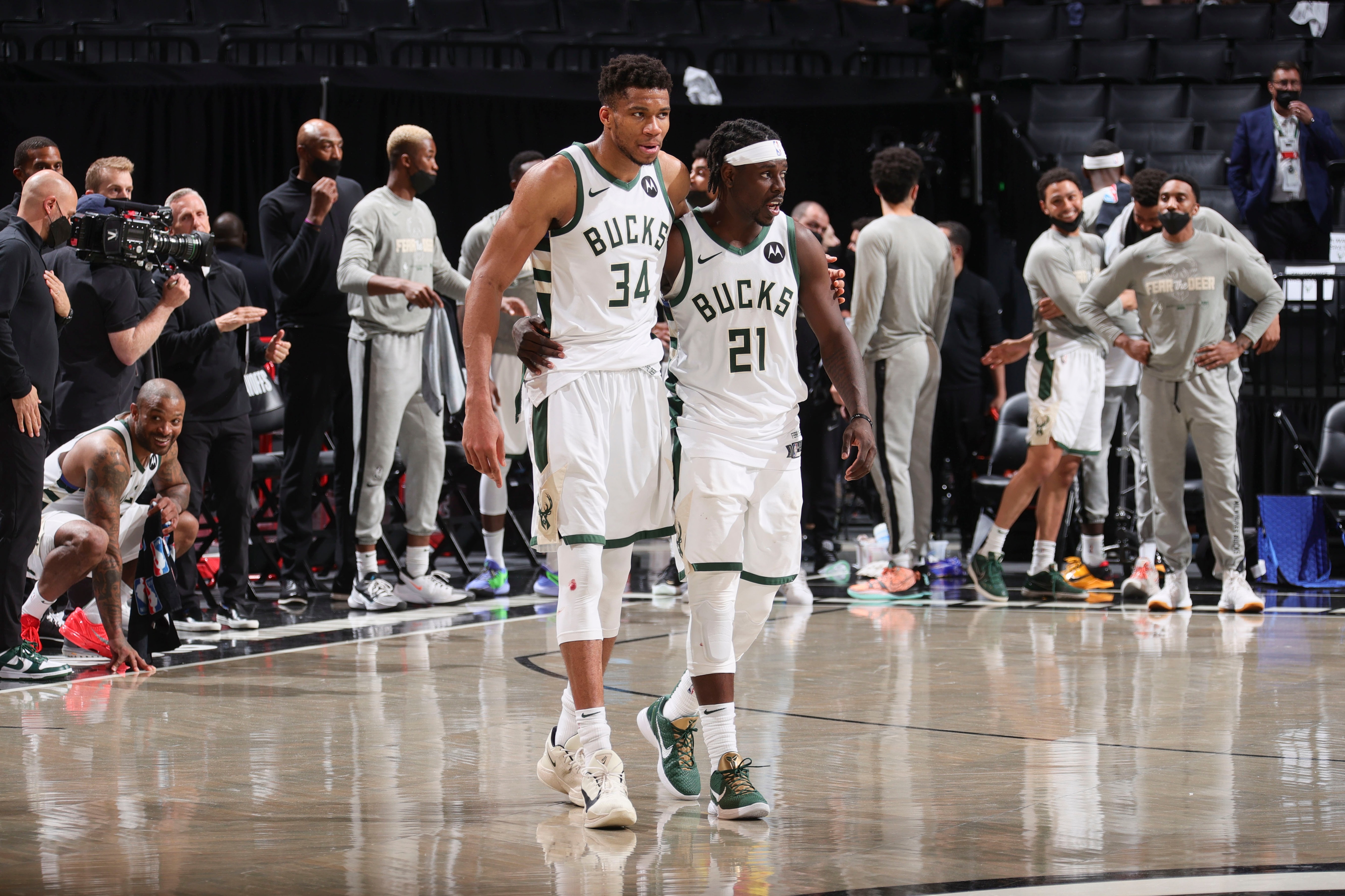 BROOKLYN, NY - JUNE 19: Giannis Antetokounmpo #34 of the Milwaukee Bucks hugs Jrue Holiday #21 of the Milwaukee Bucks after the game against the Brooklyn Nets during Round 2, Game 7 of the 2021 NBA Playoffs on June 19, 2021 at Barclays Center in Brooklyn, New York. NOTE TO USER: User expressly acknowledges and agrees that, by downloading and or using this Photograph, user is consenting to the terms and conditions of the Getty Images License Agreement. Mandatory Copyright Notice: Copyright 2021 NBAE (Photo by Nathaniel S. Butler/NBAE via Getty Images)