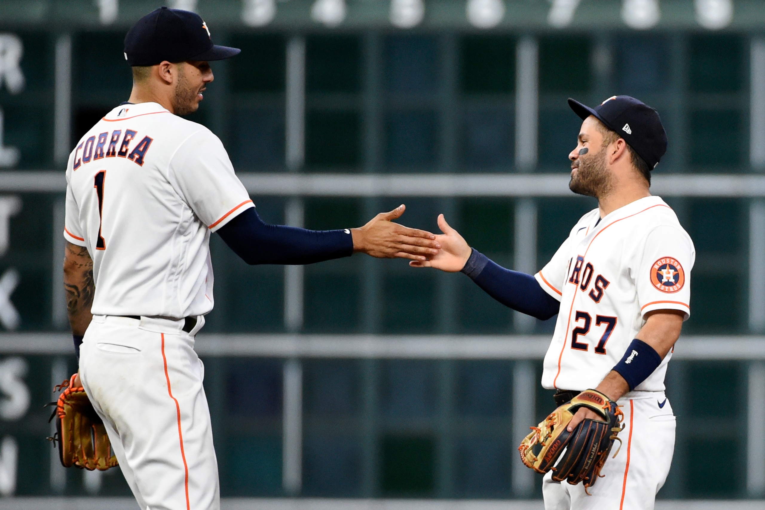 Houston Astros' Carlos Correa, left, and Jose Altuve celebrate the team's win over the Oakland Athletics in a baseball game Wednesday, July 7, 2021, in Houston. (AP Photo/Eric Christian Smith)