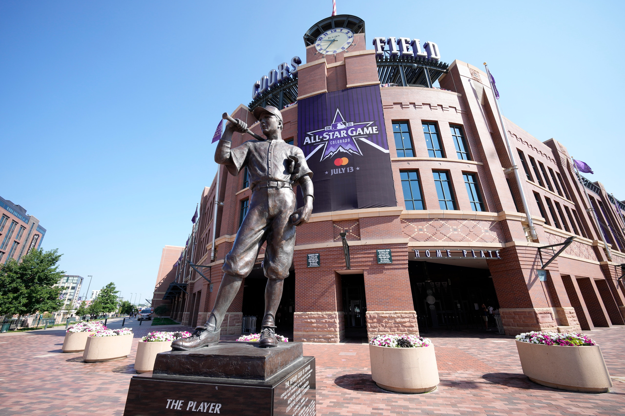 A All Star Game banner hangs from the front entrance of Coors Field behind a sculpture named "The Player" Saturday, July 10, 2021, in Denver. Preparations continue for the playing of Major League Baseball's All Star Game, which is set for Tuesday, July 13, in Coors Field. (AP Photo/David Zalubowski)