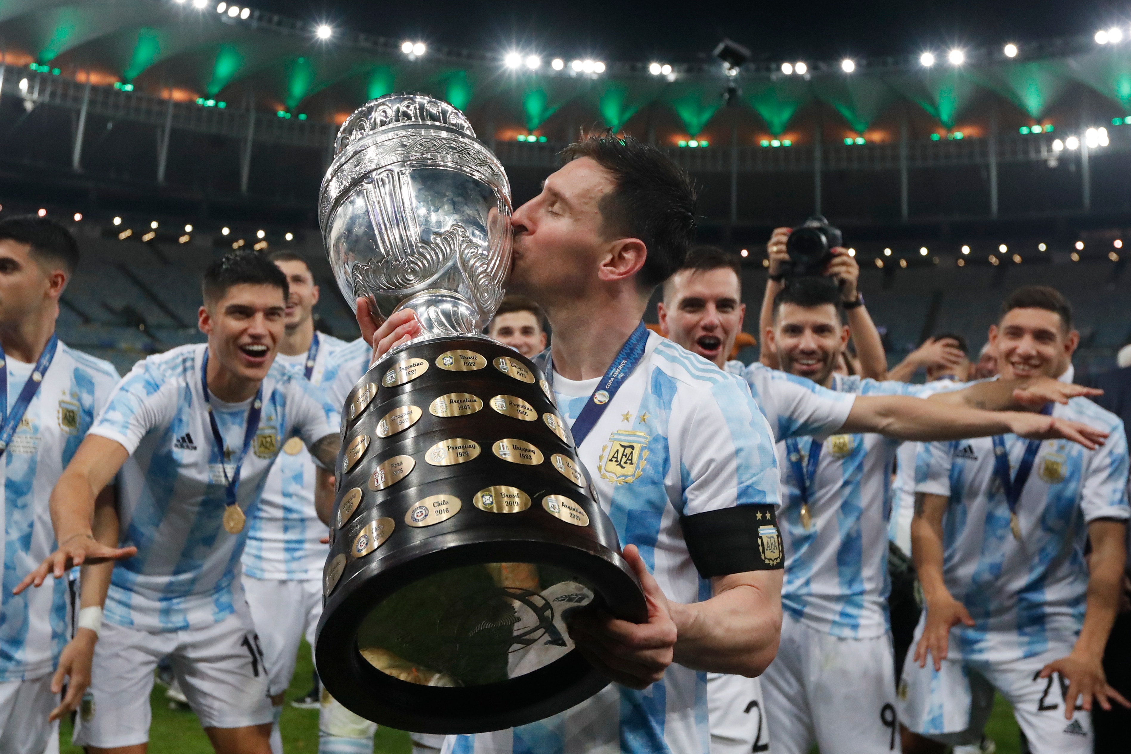 Argentina's Lionel Messi kisses the trophy after beating Brazil 1-0 in the Copa America final soccer match at Maracana stadium in Rio de Janeiro, Brazil, Saturday, July 10, 2021. (AP Photo/Bruna Prado)