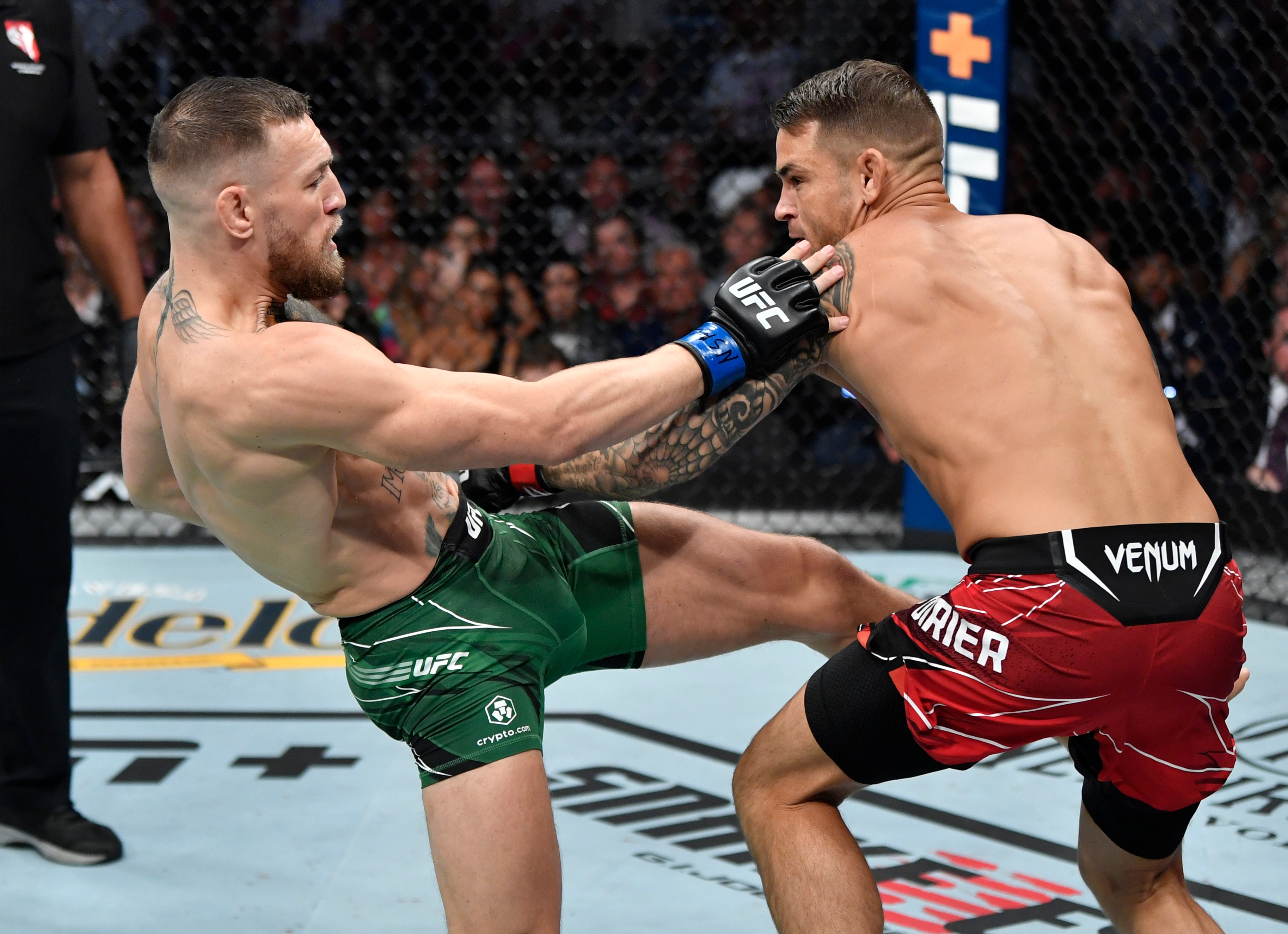 LAS VEGAS, NEVADA - JULY 10: (L-R) Conor McGregor of Ireland kicks Dustin Poirier in their welterweight fight during the UFC 264 event at T-Mobile Arena on July 10, 2021 in Las Vegas, Nevada. (Photo by Jeff Bottari/Zuffa LLC)