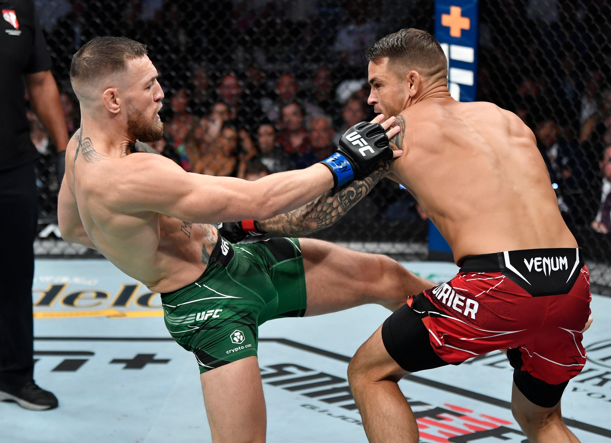 LAS VEGAS, NEVADA - JULY 10: (L-R) Conor McGregor of Ireland kicks Dustin Poirier in their welterweight fight during the UFC 264 event at T-Mobile Arena on July 10, 2021 in Las Vegas, Nevada. (Photo by Jeff Bottari/Zuffa LLC)