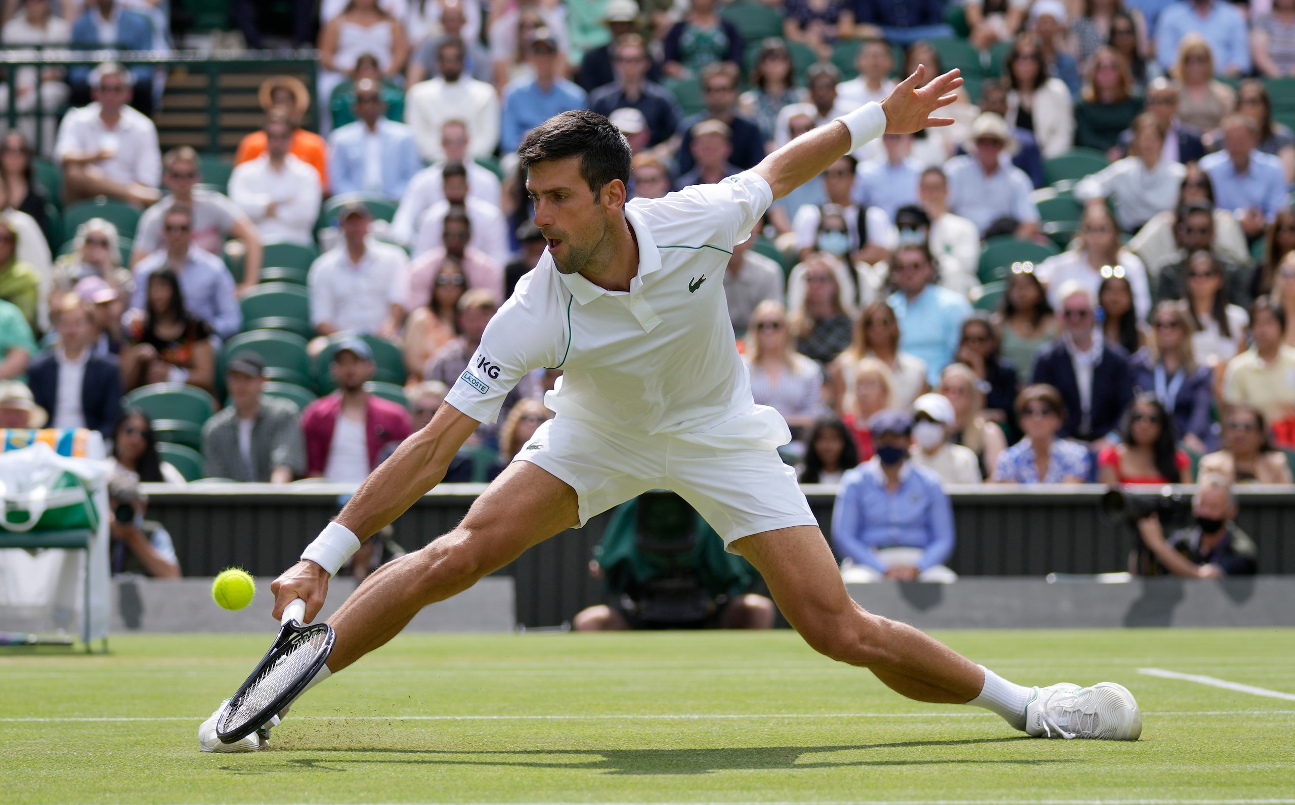 Serbia's Novak Djokovic plays a return to Italy's Matteo Berrettini during the men's singles final on day thirteen of the Wimbledon Tennis Championships in London, Sunday, July 11, 2021. (AP Photo/Kirsty Wigglesworth)