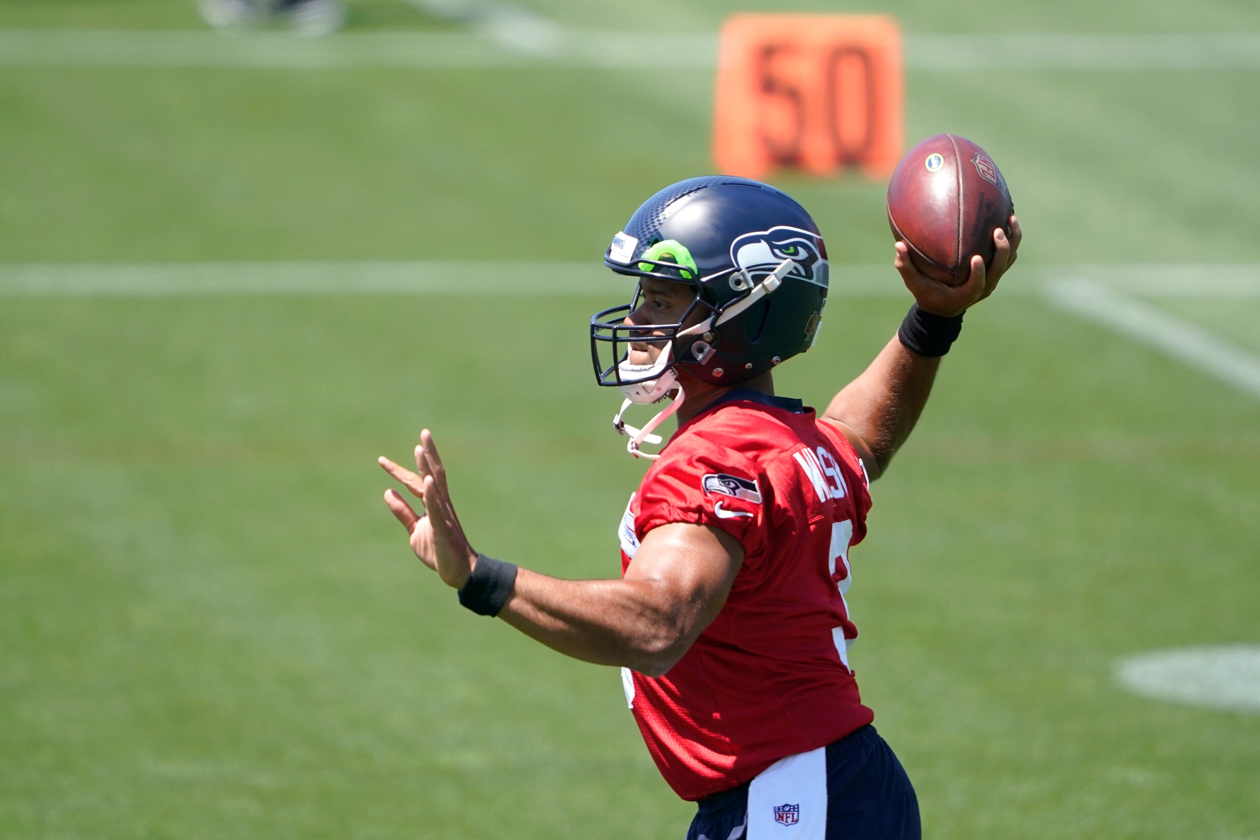 Seattle Seahawks quarterback Russell Wilson passes during NFL football practice Wednesday, June 16, 2021, in Renton, Wash. (AP Photo/Ted S. Warren)