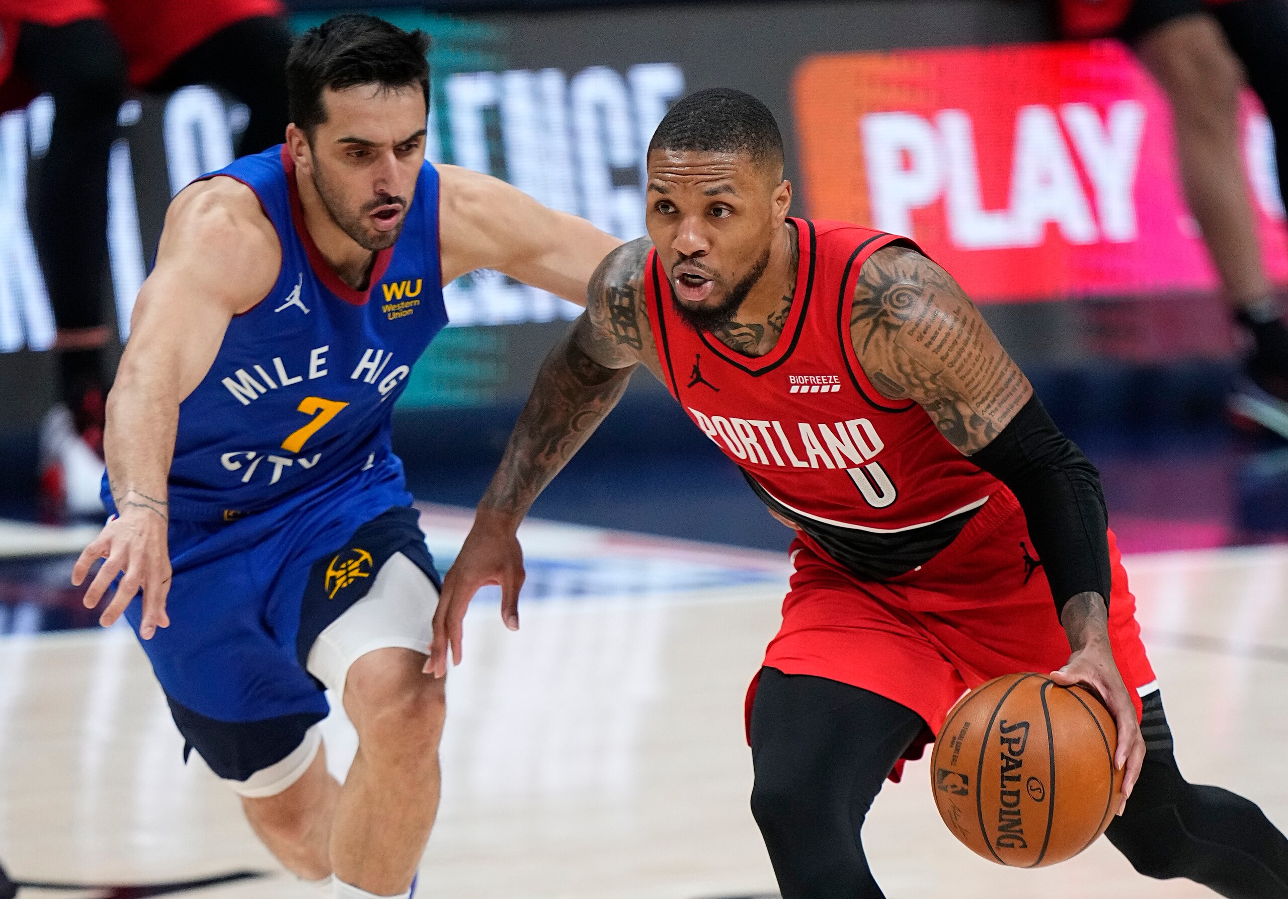 Portland Trail Blazers guard Damian Lillard (0) drives past Denver Nuggets guard Facundo Campazzo (7) in the second half of Game 1 of a first-round NBA basketball playoff series Saturday, May 22, 2021, in Denver. (AP Photo/Jack Dempsey) Portland Trail Blazers guard Damian Lillard (0) drives past Denver Nuggets guard Facundo Campazzo (7) in the second half of Game 1 of a first-round NBA basketball playoff series Saturday, May 22, 2021, in Denver. (AP Photo/Jack Dempsey)