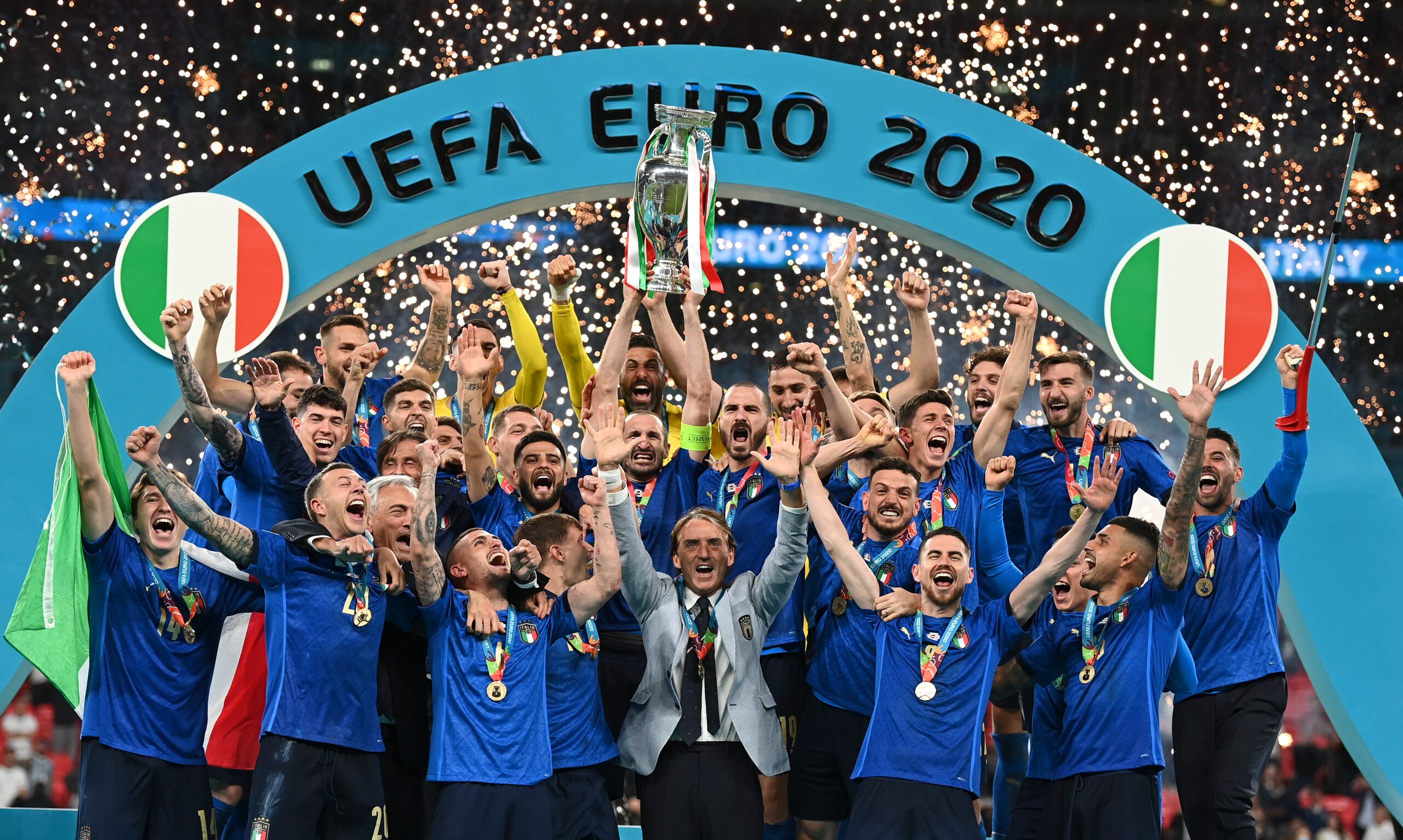 Italy's team celebrates with the trophy on the podium after winning the Euro 2020 soccer championship final between England and Italy at Wembley stadium in London, Sunday, July 11, 2021. (Michael Regan/Pool via AP)
