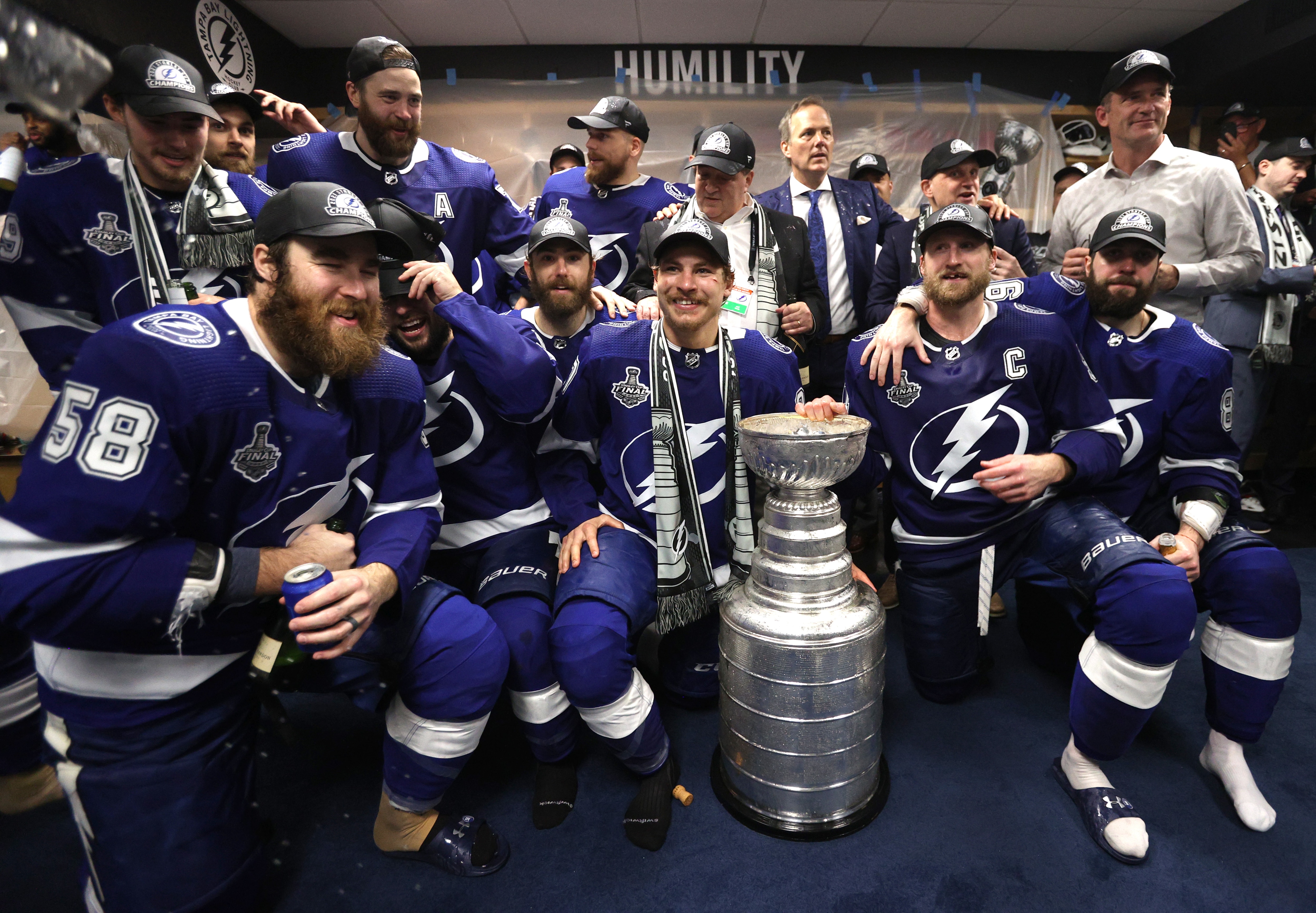 TAMPA, FLORIDA - JULY 07: The Tampa Bay Lightning celebrate with the Stanley Cup in the locker room after their 1-0 victory in Game Five of the 2021 Stanley Cup Final to win the series four games to one against the Montreal Canadiens at Amalie Arena on July 07, 2021 in Tampa, Florida. (Photo by Dave Sandford/NHLI via Getty Images)