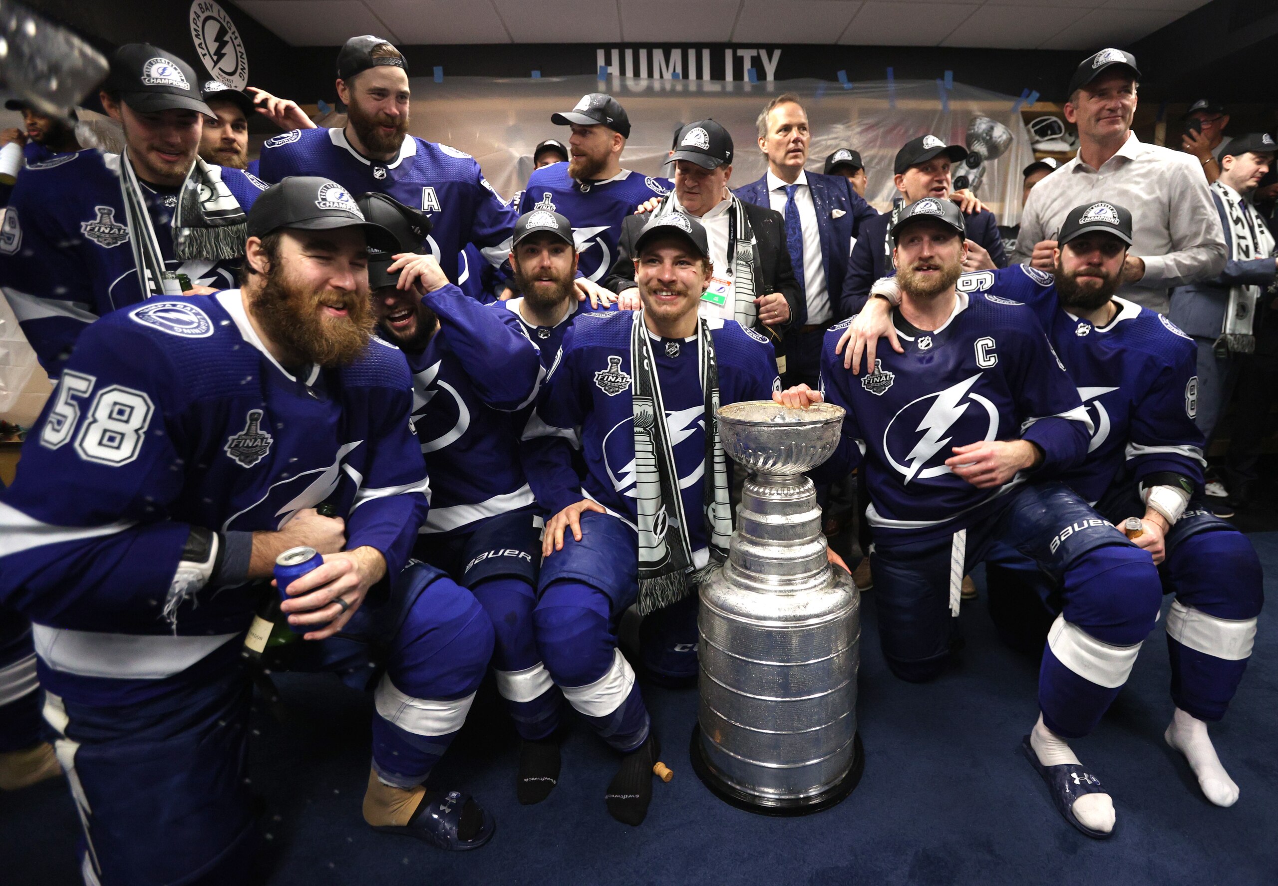 TAMPA, FLORIDA - JULY 07: The Tampa Bay Lightning celebrate with the Stanley Cup in the locker room after their 1-0 victory in Game Five of the 2021 Stanley Cup Final to win the series four games to one against the Montreal Canadiens at Amalie Arena on July 07, 2021 in Tampa, Florida. (Photo by Dave Sandford/NHLI via Getty Images)