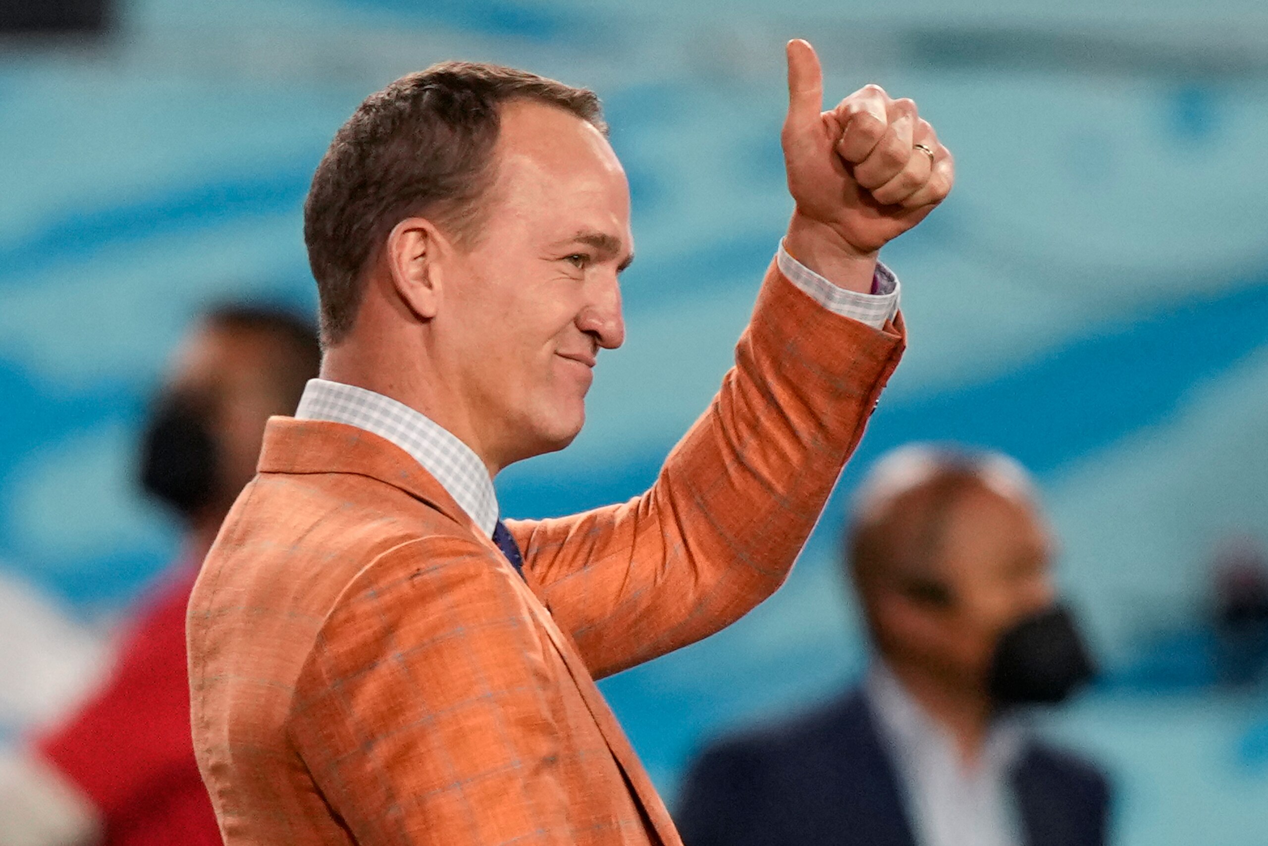 Former quarterback Peyton Manning motions to the crowd during the NFL Super Bowl 55 football game between the Tampa Bay Buccaneers and the Kansas City Chiefs, Sunday, Feb. 7, 2021, in Tampa, Fla. (AP Photo/David J. Phillip)
