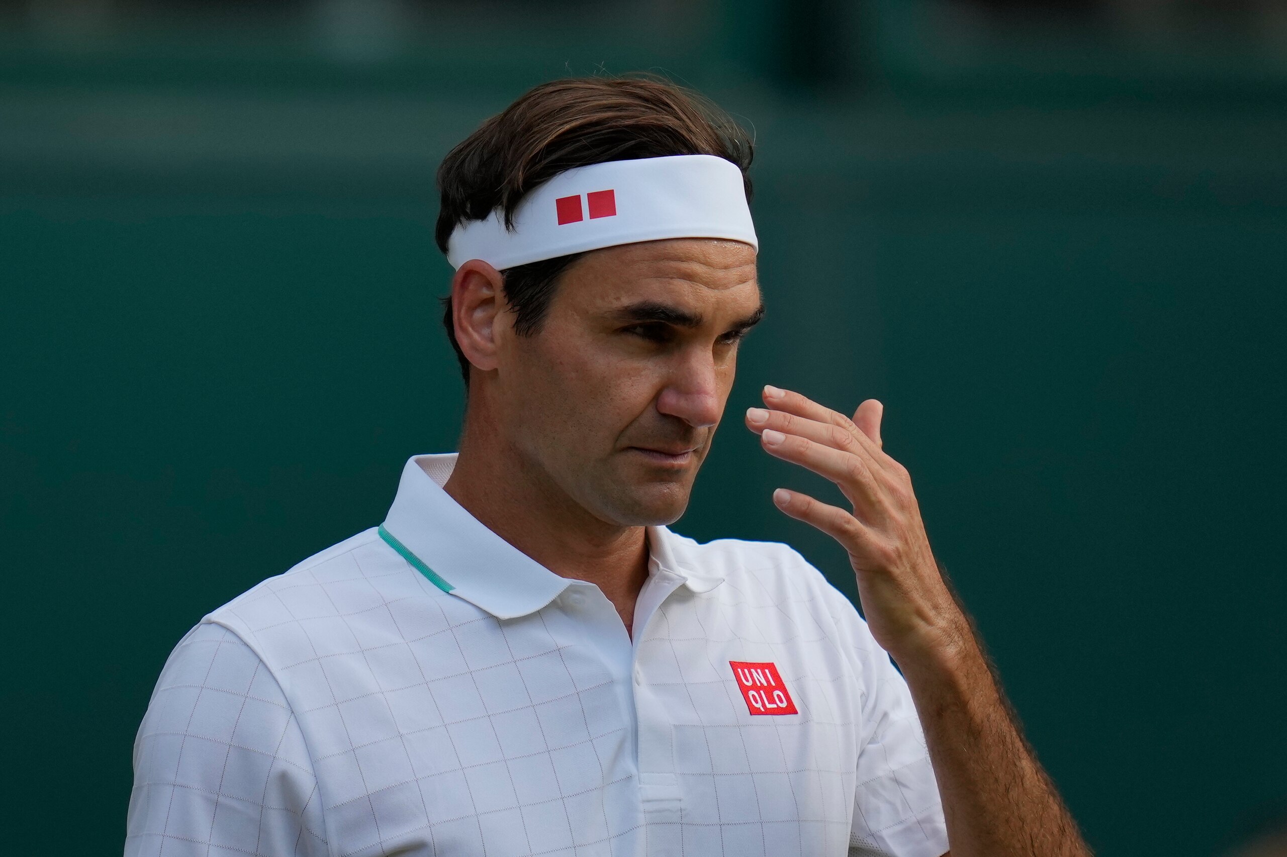 Switzerland's Roger Federer reacts during the men's singles quarterfinals match against Poland's Hubert Hurkacz on day nine of the Wimbledon Tennis Championships in London, Wednesday, July 7, 2021. (AP Photo/Kirsty Wigglesworth)
