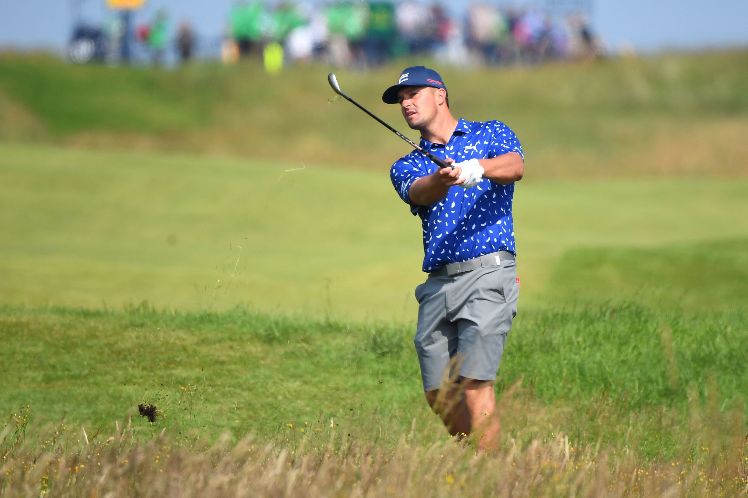 US golfer Bryson DeChambeau plays from the rough on the 18th hole during a practice round for The 149th British Open Golf Championship at Royal St George's, Sandwich in south-east England on July 13, 2021. - RESTRICTED TO EDITORIAL USE (Photo by ANDY BUCHANAN / AFP) / RESTRICTED TO EDITORIAL USE (Photo by ANDY BUCHANAN/AFP via Getty Images)