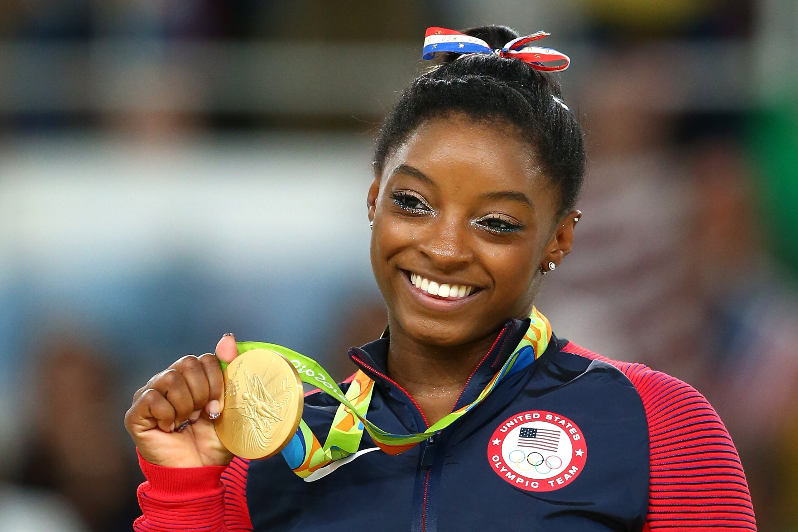 RIO DE JANEIRO, BRAZIL - AUGUST 16:  Gold medalist Simone Biles of the United States celebrates on the podium at the medal ceremony for the Women's Floor on Day 11 of the Rio 2016 Olympic Games at the Rio Olympic Arena on August 16, 2016 in Rio de Janeiro, Brazil.  (Photo by Alex Livesey/Getty Images)