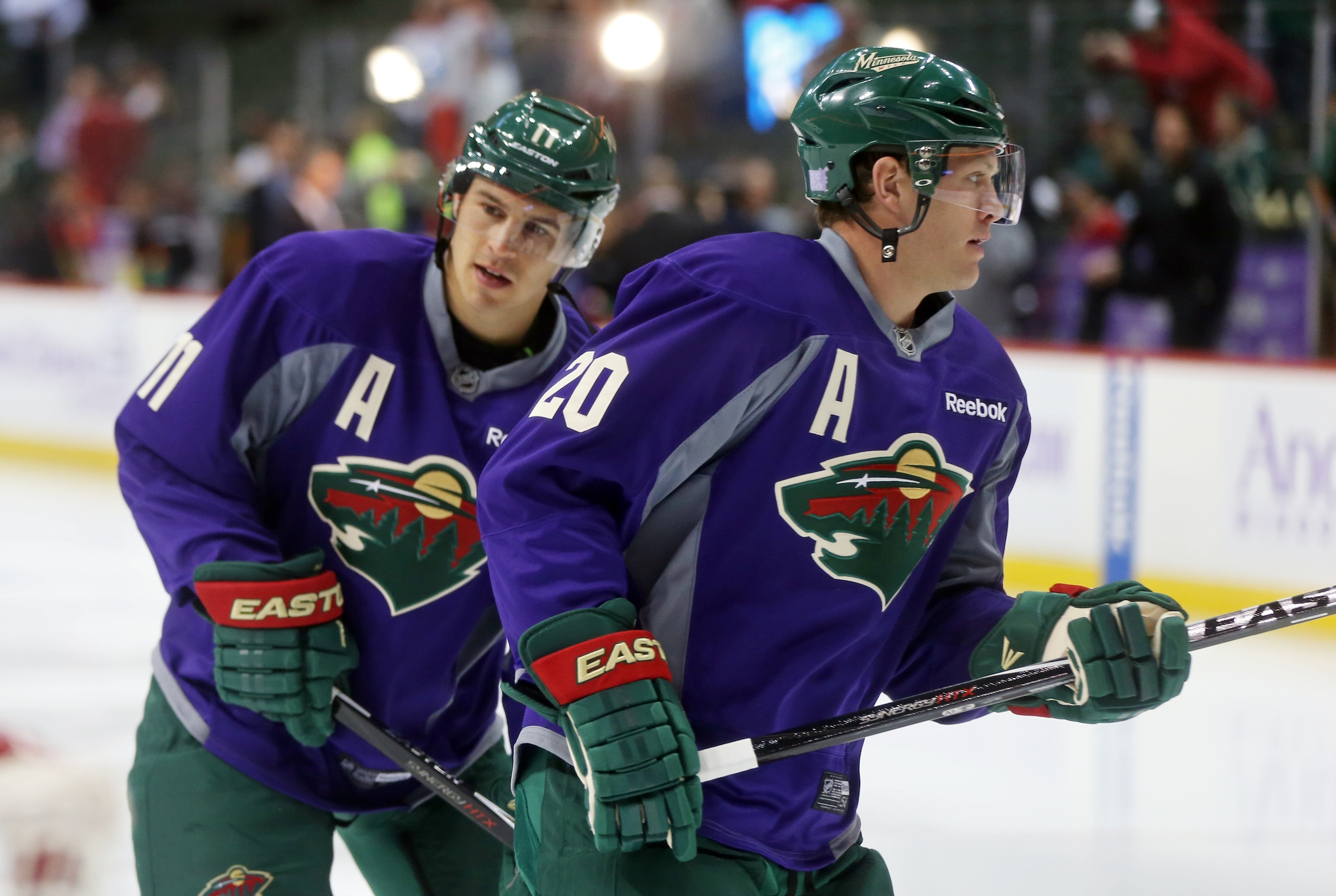 Minnesota Wild's Zach Parise, left, and Ryan Suter warm up prior to an NHL hockey game against the Arizona Coyotes, Thursday, Oct. 23, 2014, in St. Paul, Minn. (AP Photo/Jim Mone)