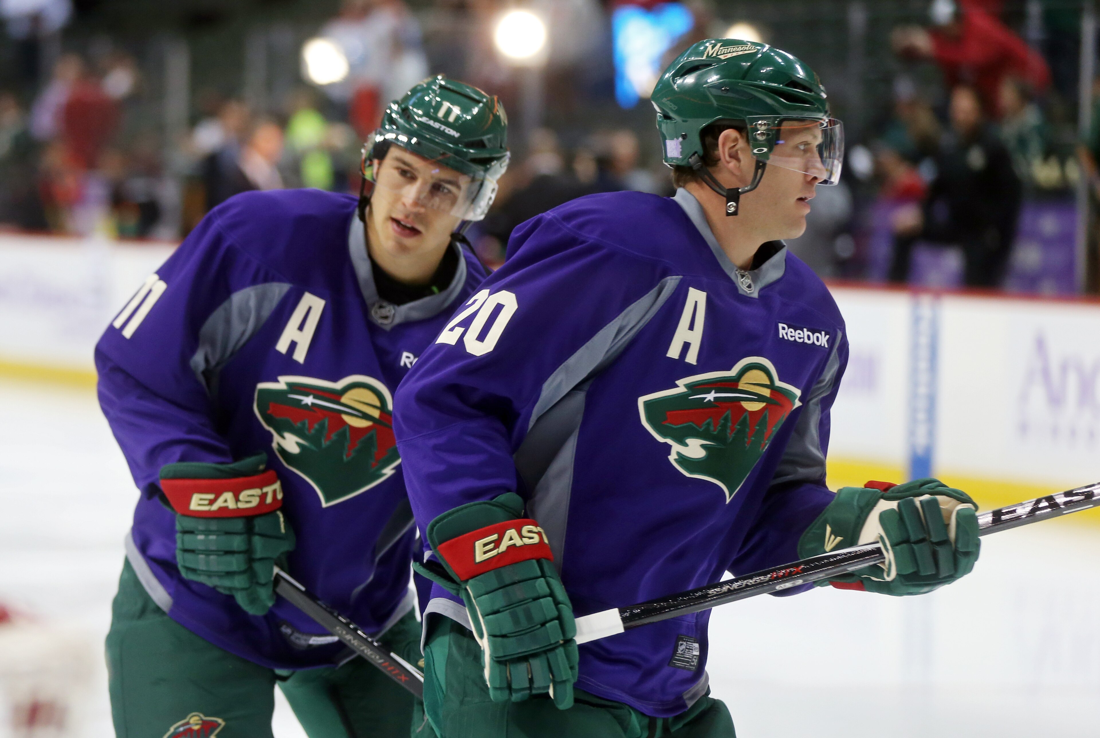 Minnesota Wild's Zach Parise, left, and Ryan Suter warm up prior to an NHL hockey game against the Arizona Coyotes, Thursday, Oct. 23, 2014, in St. Paul, Minn. (AP Photo/Jim Mone)