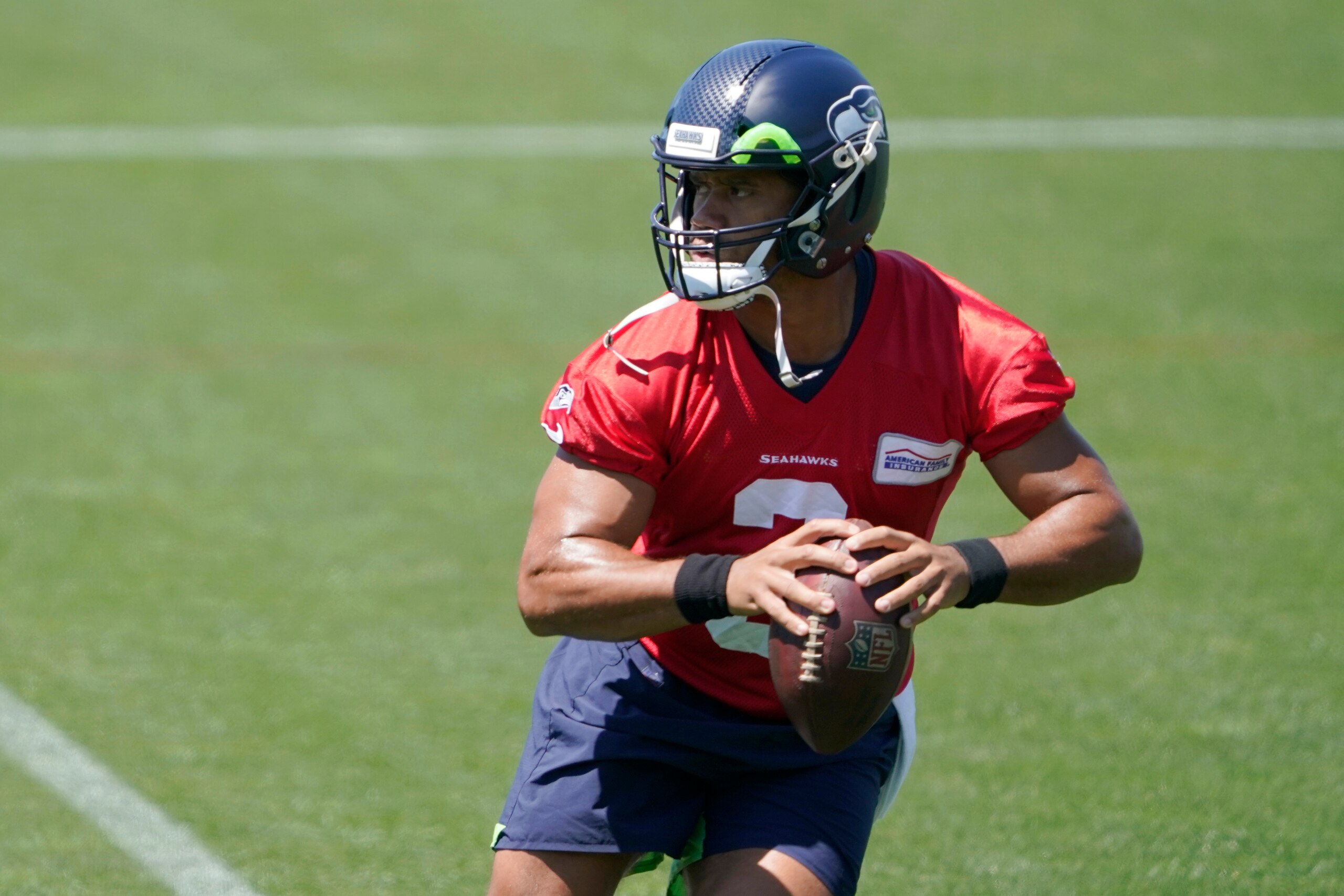 Seattle Seahawks quarterback Russell Wilson drops to pass during NFL football practice Wednesday, June 16, 2021, in Renton, Wash. (AP Photo/Ted S. Warren)
