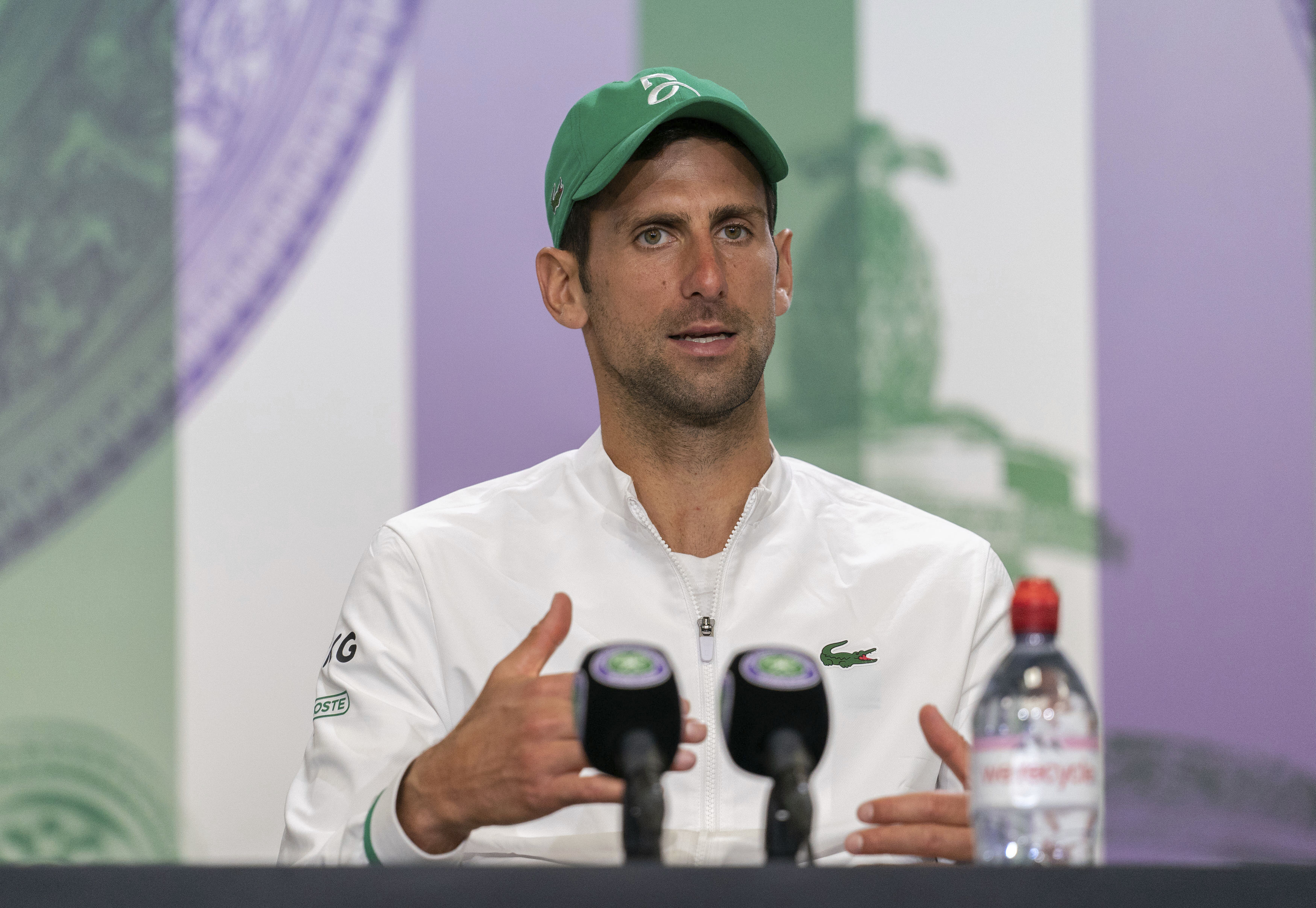 Novak Djokovic attends a press conference after winning the men's final against Italy's Matteo Berrettini at the Wimbledon Tennis Championships in London, Sunday, July 11, 2021. (Joe Toth/Pool via AP)