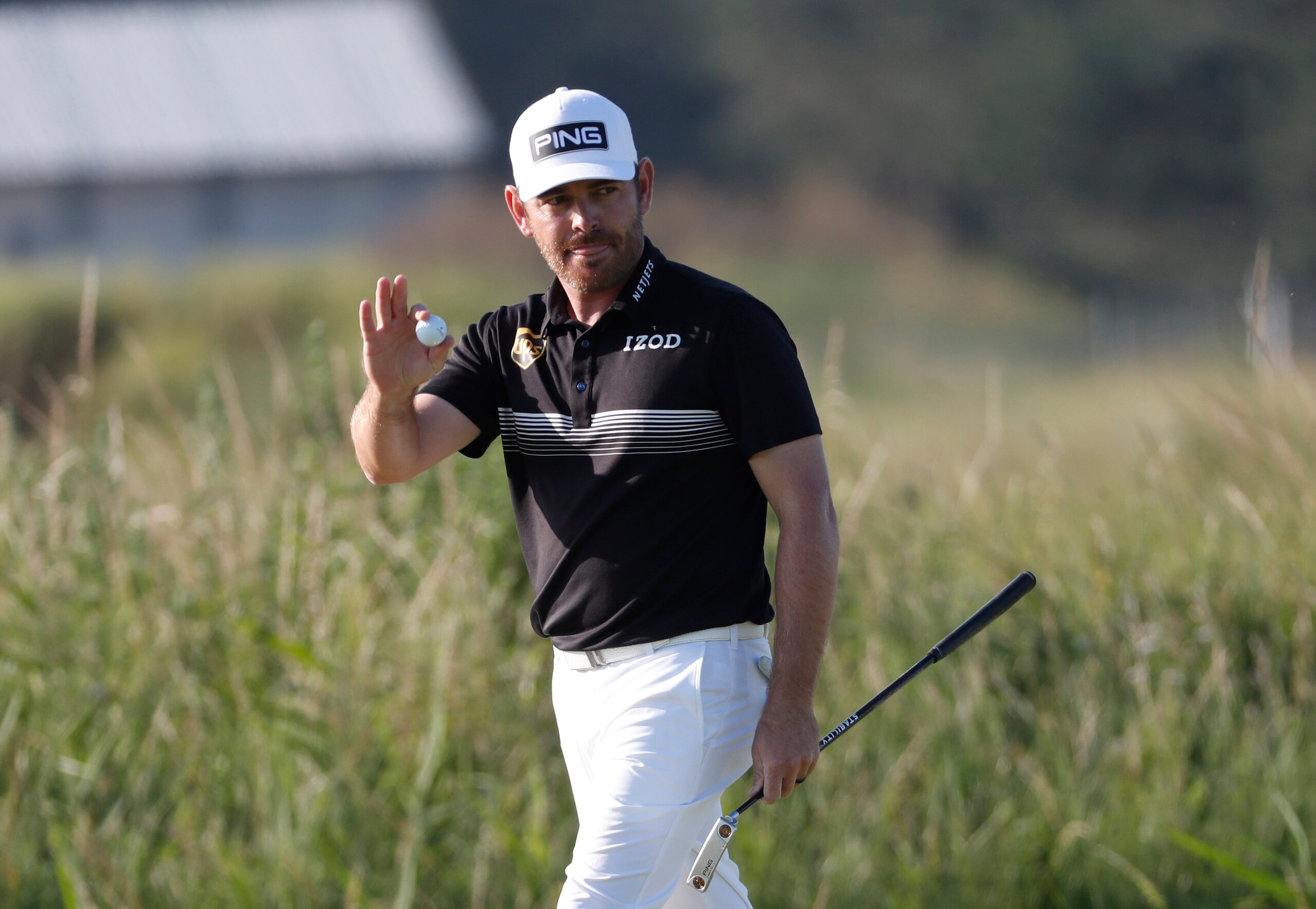South Africa's Louis Oosthuizen acknowledges the crowd after putting an eagle on the 14th green during the second round of the British Open Golf Championship at Royal St George's golf course Sandwich, England, Friday, July 16, 2021. (AP Photo/Peter Morrison)