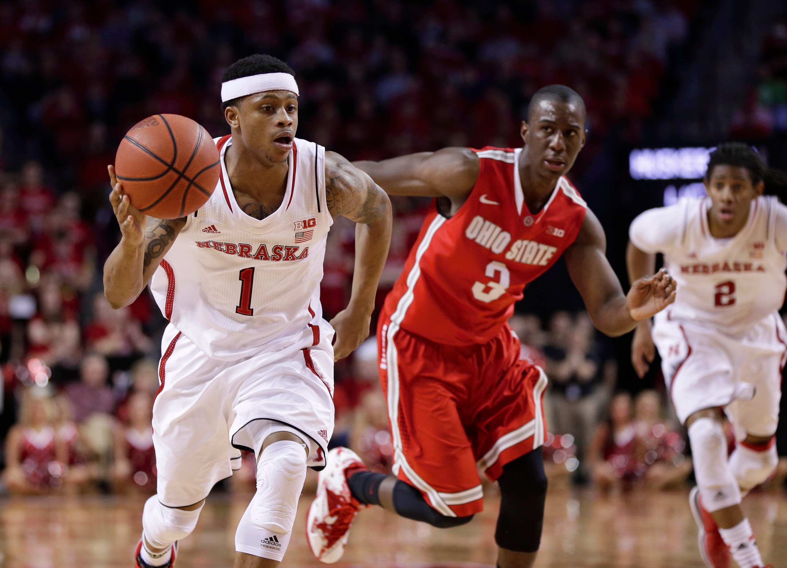 Nebraska's Deverell Biggs (1) drives past Ohio State guard Shannon Scott (3), with Nebraska's David Rivers (2) following, in the second half of an NCAA college basketball game in Lincoln, Neb., Monday, Jan. 20, 2014. Nebraska won 68-62. (AP Photo/Nati Harnik)