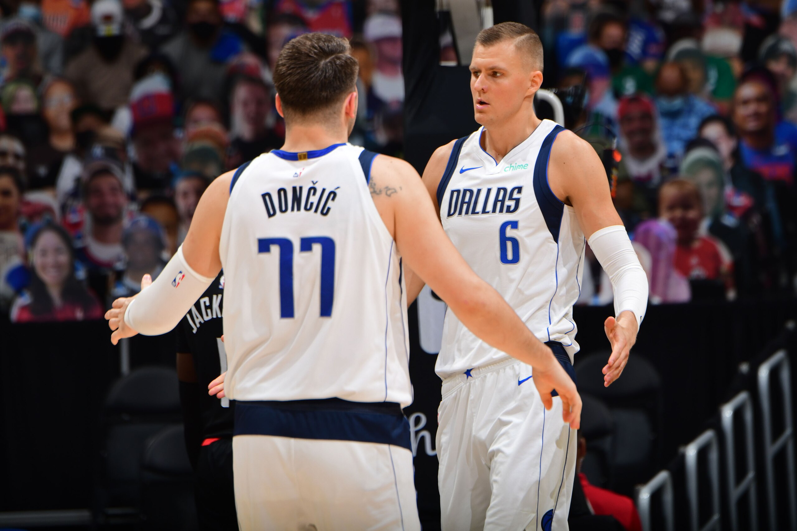 LOS ANGELES, CA - MAY 25: Luka Doncic #77 and Kristaps Porzingis #6 of the Dallas Mavericks hi-five during the game against the LA Clippers during Round 1, Game 2 of the 2021 NBA Playoffs on May 25, 2021 at STAPLES Center in Los Angeles, California. NOTE TO USER: User expressly acknowledges and agrees that, by downloading and/or using this Photograph, user is consenting to the terms and conditions of the Getty Images License Agreement. Mandatory Copyright Notice: Copyright 2021 NBAE (Photo by Adam Pantozzi/NBAE via Getty Images)
