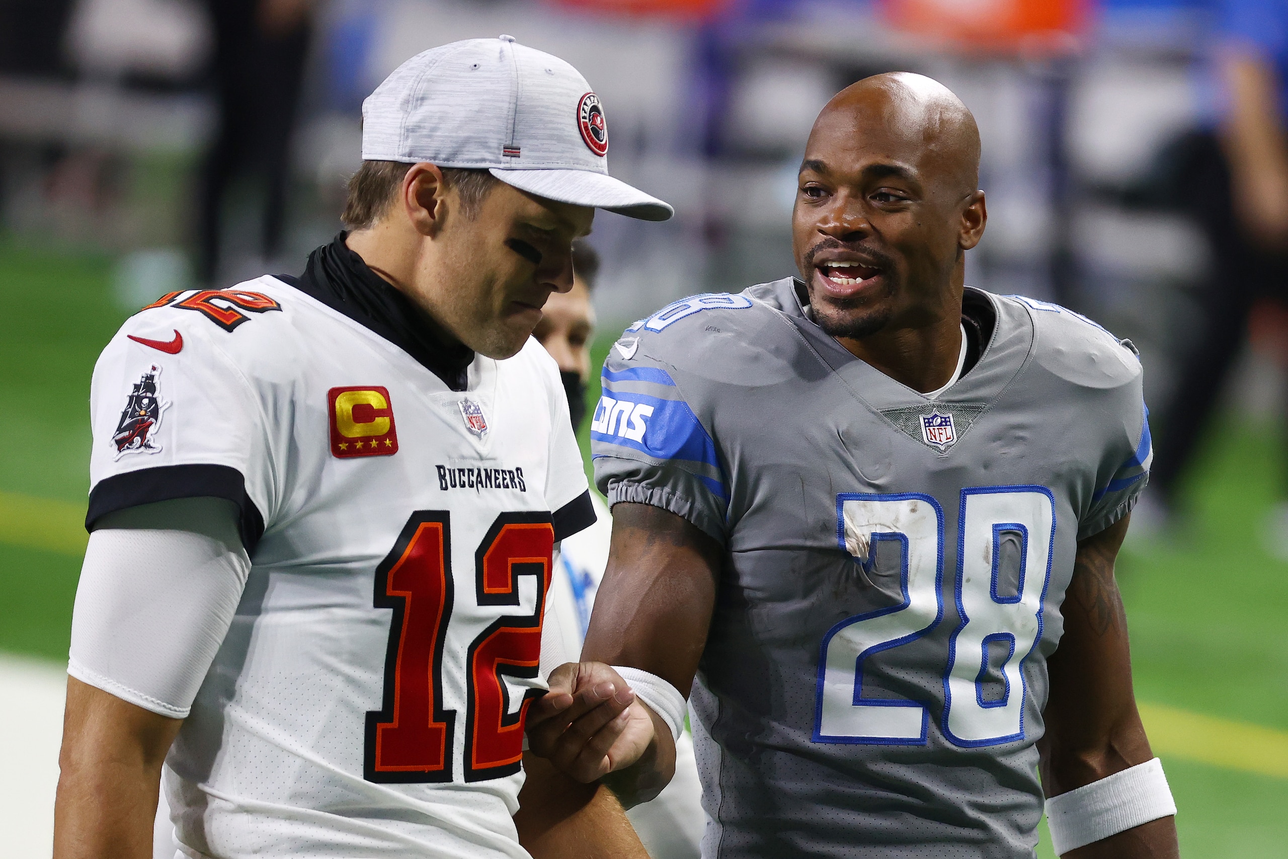 DETROIT, MICHIGAN - DECEMBER 26: Tom Brady #12 of the Tampa Bay Buccaneers speaks with Adrian Peterson #28 of the Detroit Lions following a game at Ford Field on December 26, 2020 in Detroit, Michigan. (Photo by Rey Del Rio/Getty Images) DETROIT, MICHIGAN - DECEMBER 26: Tom Brady #12 of the Tampa Bay Buccaneers speaks with Adrian Peterson #28 of the Detroit Lions following a game at Ford Field on December 26, 2020 in Detroit, Michigan. (Photo by Rey Del Rio/Getty Images)