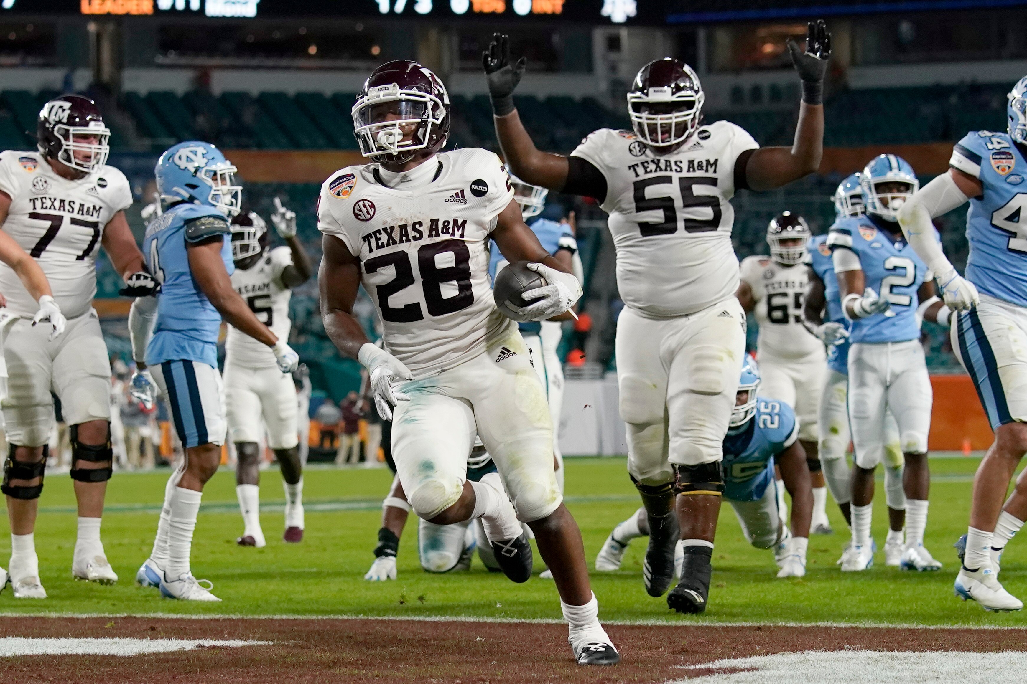 Texas A&M running back Isaiah Spiller (28) runs to score a touchdown during the first half of the Orange Bowl NCAA college football game against North Carolina, Saturday, Jan. 2, 2021, in Miami Gardens, Fla.(AP Photo/Lynne Sladky)