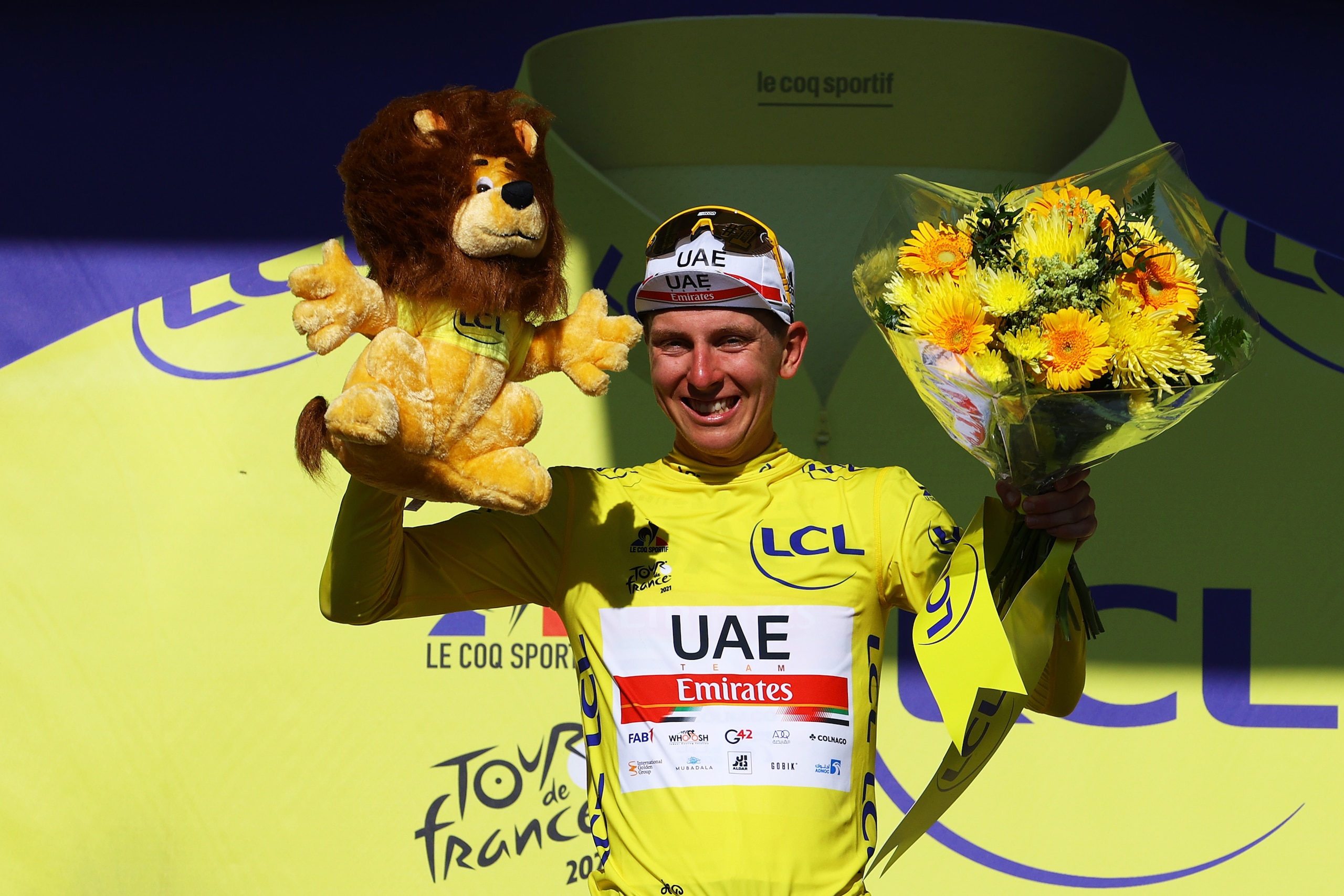 SAINT-EMILION, FRANCE - JULY 17: Tadej PogaÄar of Slovenia and UAE-Team Emirates yellow leader jersey celebrates at podium during the 108th Tour de France 2021, Stage 20 a 30,8km Individual Time Trial Stage from Libourne to Saint-Emilion 75m / Lion Mascot / ITT / @LeTour / #TDF2021 / on July 17, 2021 in Saint-Emilion, France. (Photo by Tim de Waele/Getty Images)