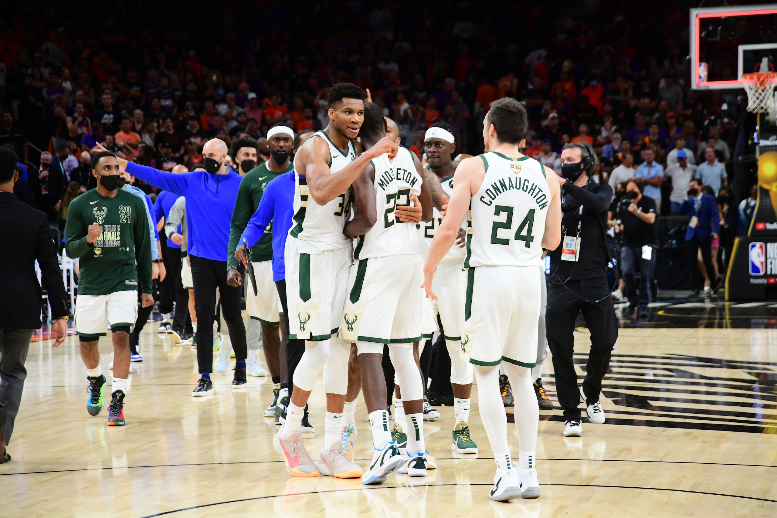 PHOENIX, AZ - July 17: Giannis Antetokounmpo #34 and Khris Middleton #22 of the Milwaukee Bucks embrace after  Game Five of the 2021 NBA Finals on July 17, 2021 at Footprint Center in Phoenix, Arizona. NOTE TO USER: User expressly acknowledges and agrees that, by downloading and or using this photograph, user is consenting to the terms and conditions of the Getty Images License Agreement. Mandatory Copyright Notice: Copyright 2021 NBAE (Photo by Michael Gonzales/NBAE via Getty Images)
