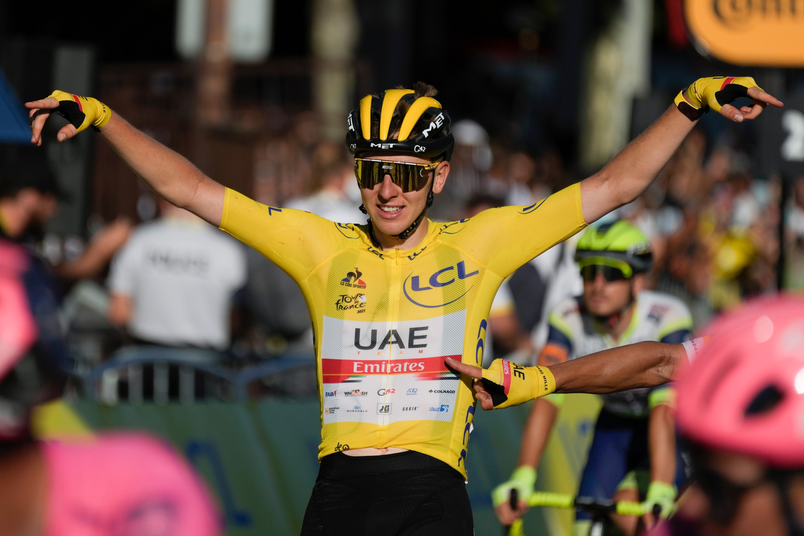 Tour de France winner Slovenia's Tadej Pogacar, wearing the overall leader's yellow jersey, celebrates as he crosses the finish line of the twenty-first and last stage of the Tour de France cycling race over 108.4 kilometers (67.4 miles) with start in Chatou and finish on the Champs Elysees in Paris, France,Sunday, July 18, 2021. (AP Photo/Daniel Cole)