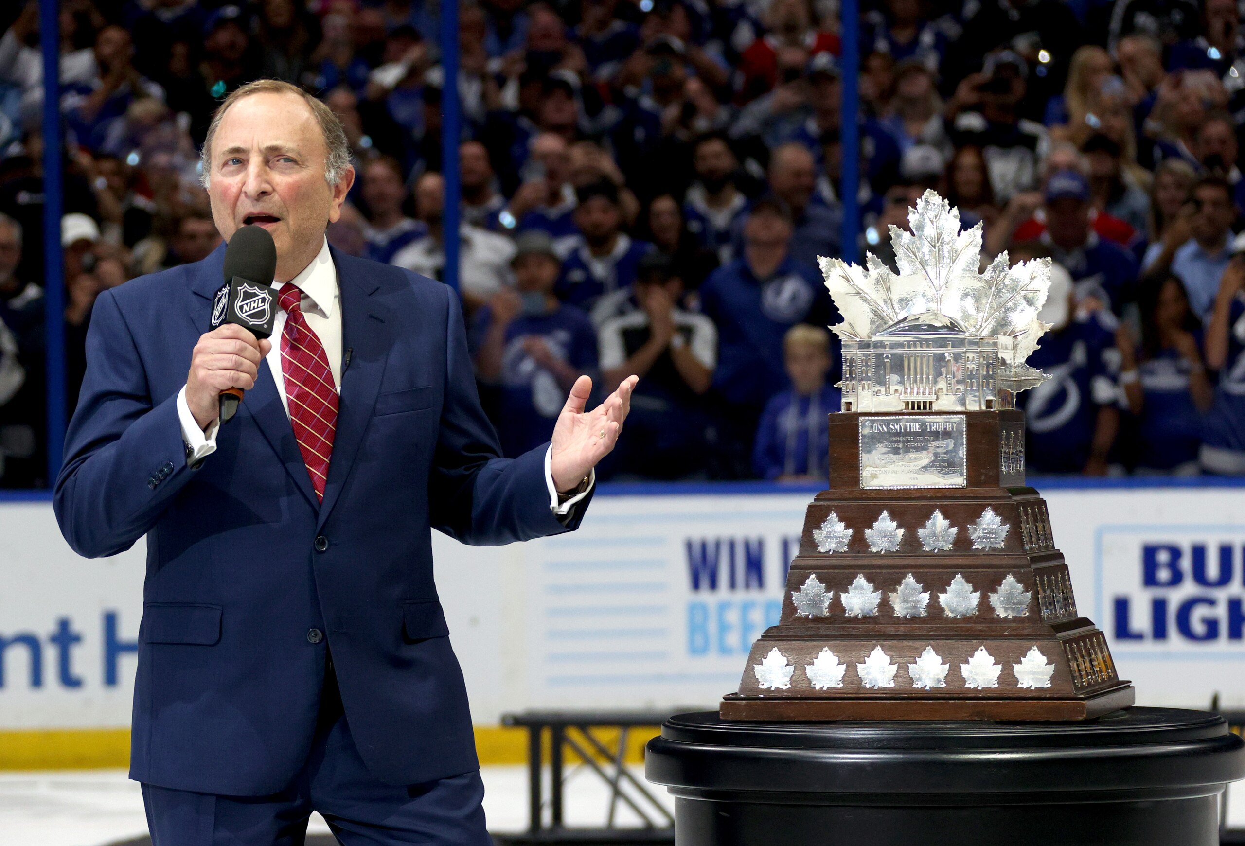 TAMPA, FLORIDA - JULY 07: NHL Commissioner Gary Bettman presents the Conn Smythe Trophy after the Tampa Bay Lightning 1-0 victory in Game Five of the 2021 Stanley Cup Final to win the series four games to one against the Montreal Canadiens at Amalie Arena on July 07, 2021 in Tampa, Florida. (Photo by Dave Sandford/NHLI via Getty Images) TAMPA, FLORIDA - JULY 07: NHL Commissioner Gary Bettman presents the Conn Smythe Trophy after the Tampa Bay Lightning 1-0 victory in Game Five of the 2021 Stanley Cup Final to win the series four games to one against the Montreal Canadiens at Amalie Arena on July 07, 2021 in Tampa, Florida. (Photo by Dave Sandford/NHLI via Getty Images)
